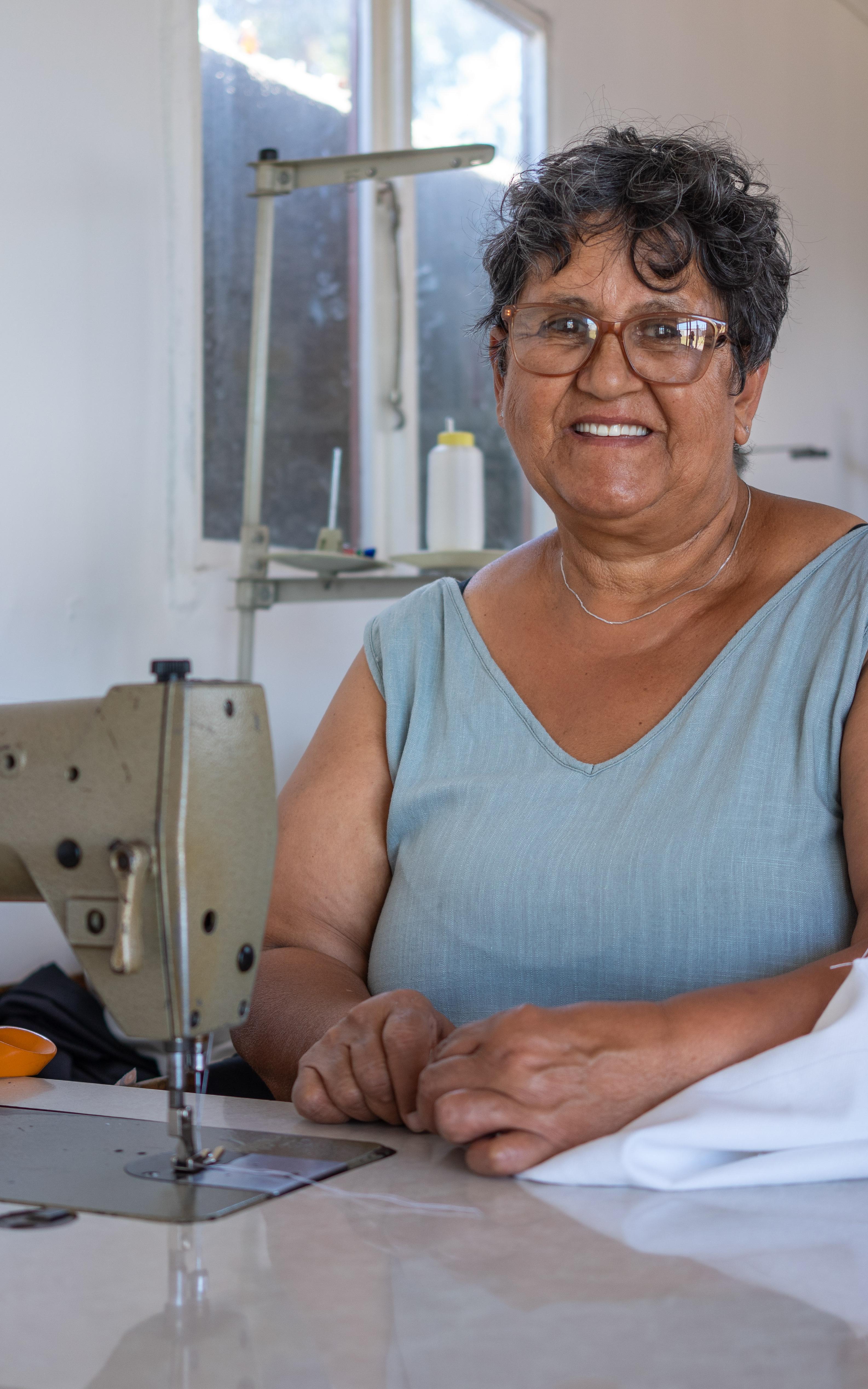 Beautiful News-Woman smiling with sewing machine. 