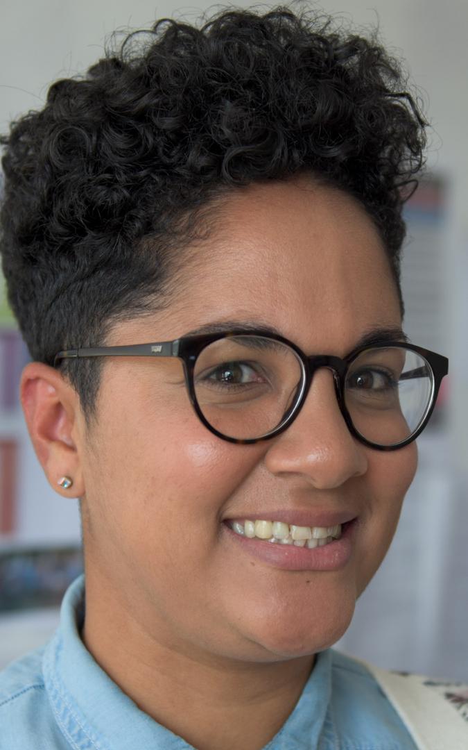 Lady wearing glasses, smiling at camera