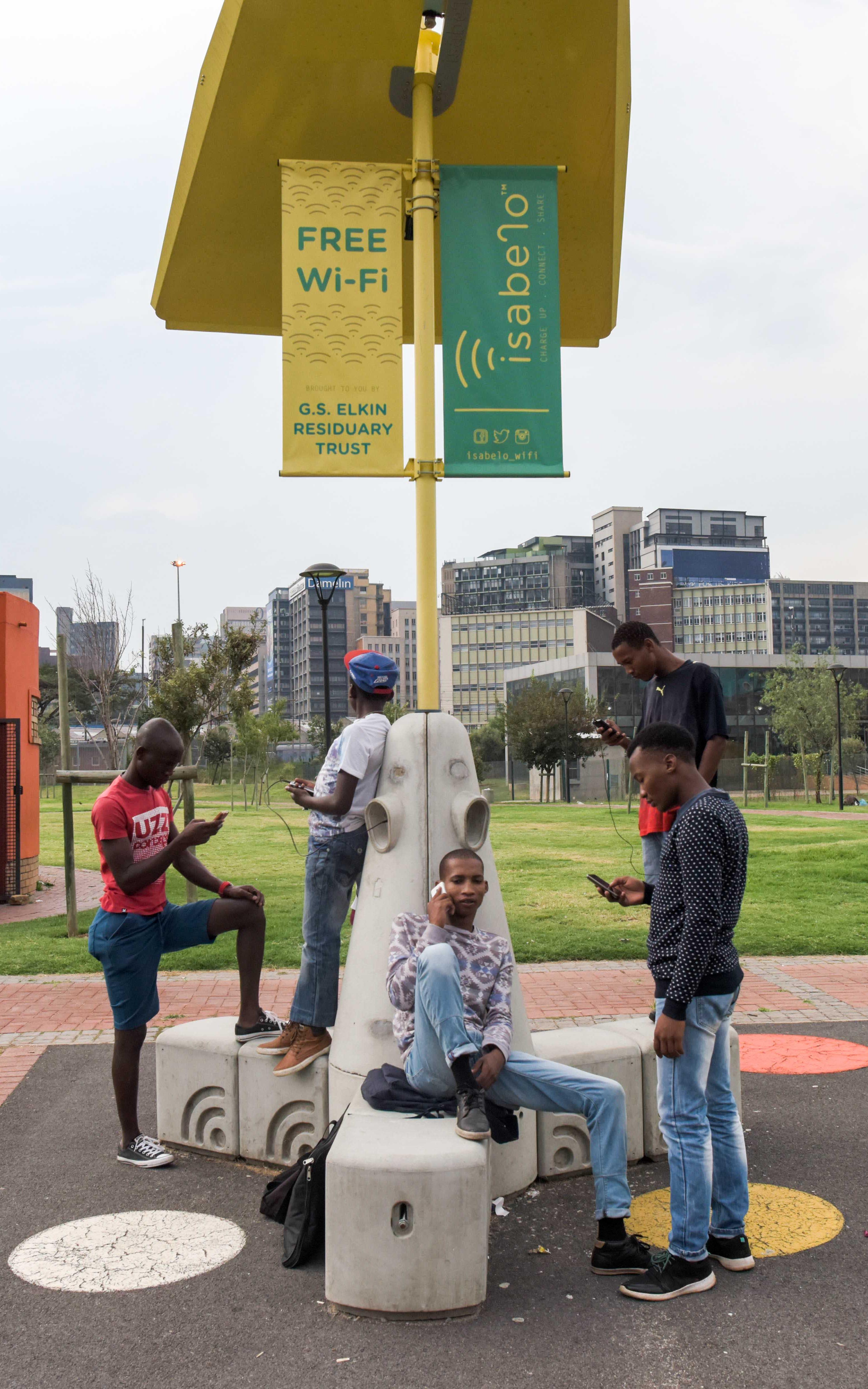 Teenagers sitting on WIFI bench