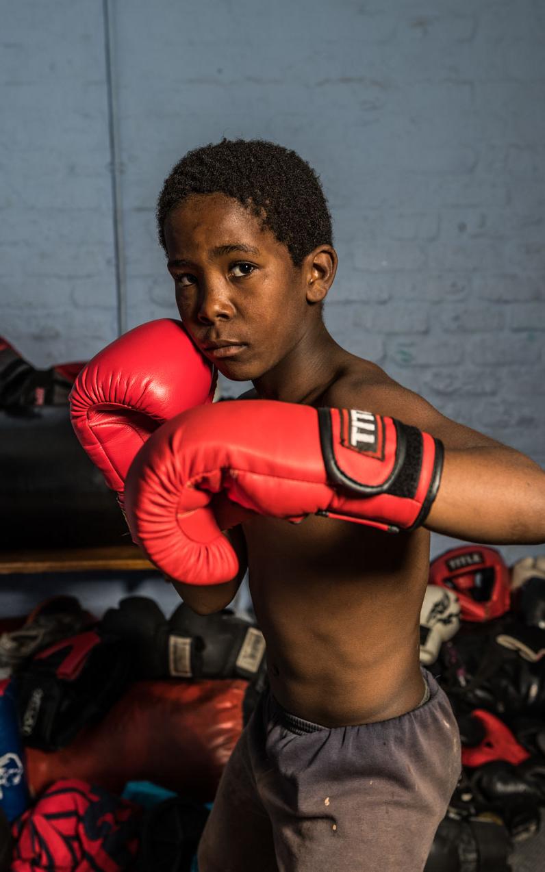 Black boy with boxing gloves.