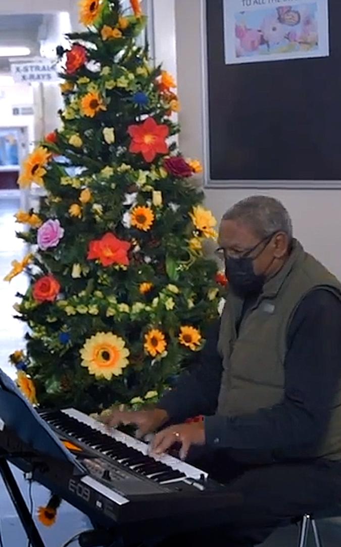 Beautiful News-Men playing music in a hospital.