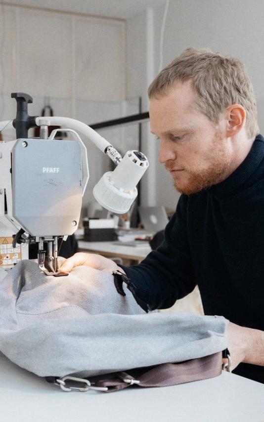 Beautiful News-Man with sewing machine.