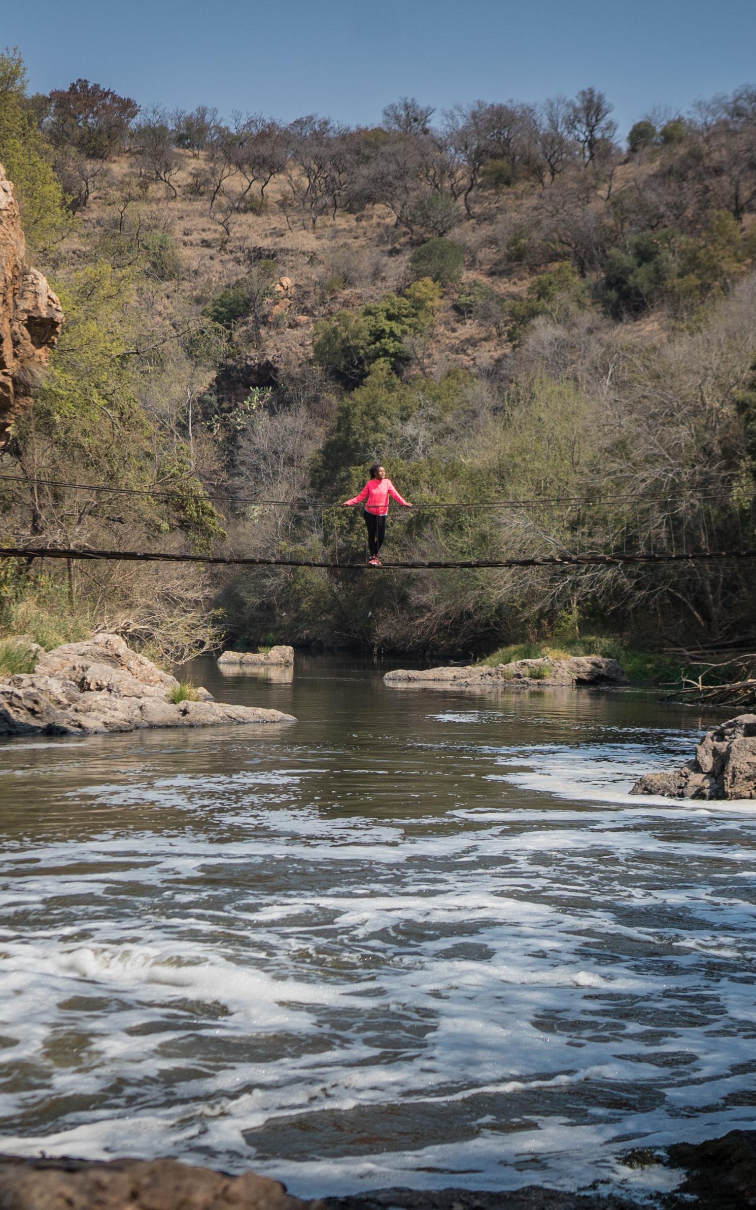 Woman standing on a bridge over water