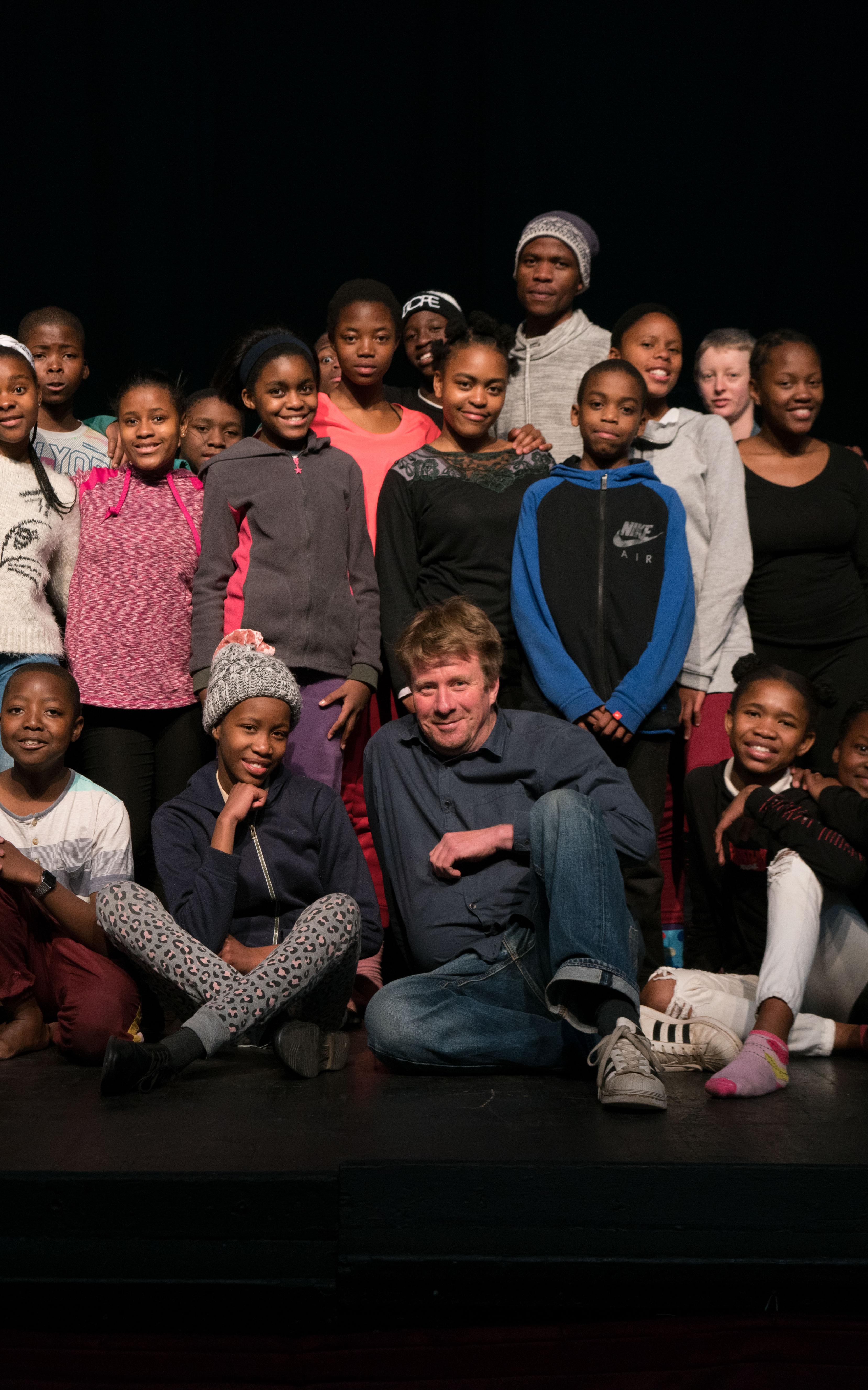 Man posing with group of children