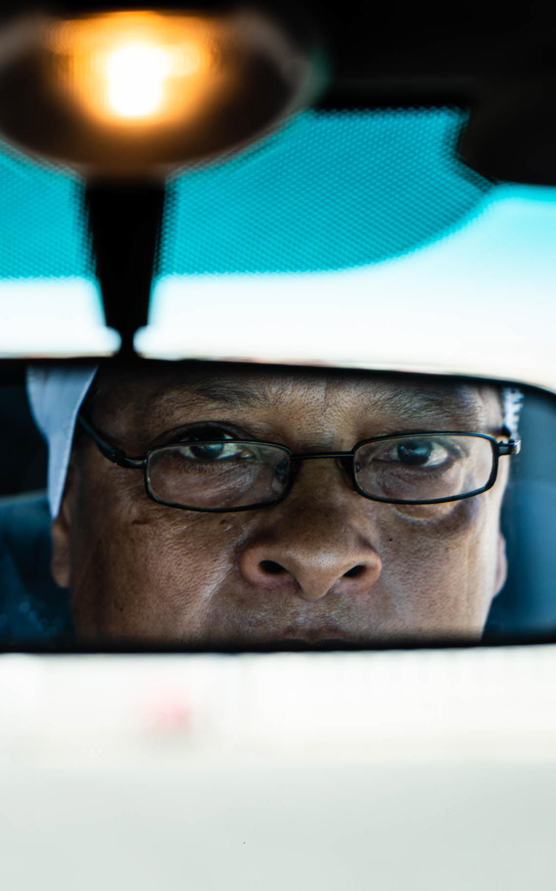 Woman looking in rearview mirror