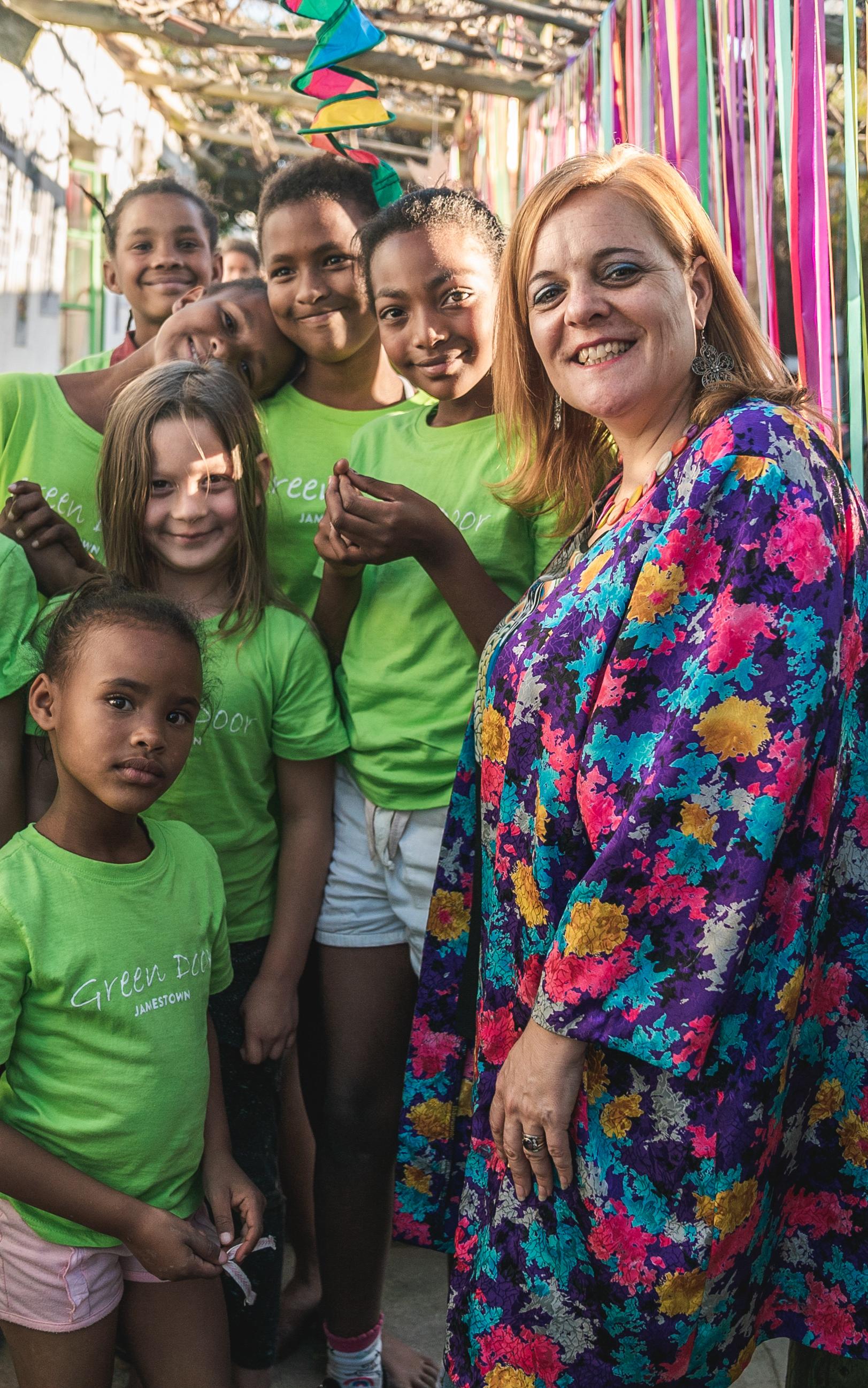 Woman and group of girls smiling to camera