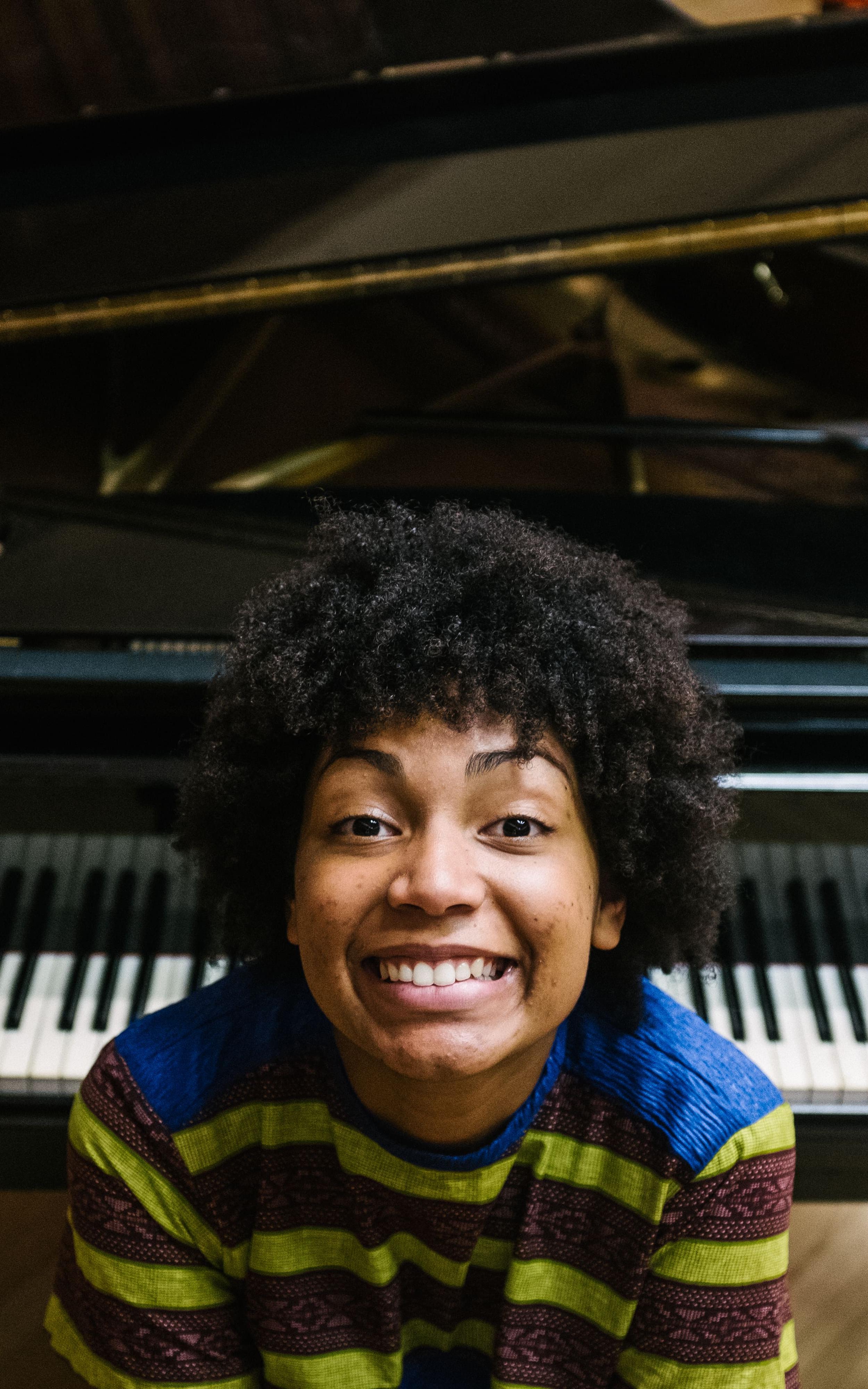 girl smiling by piano