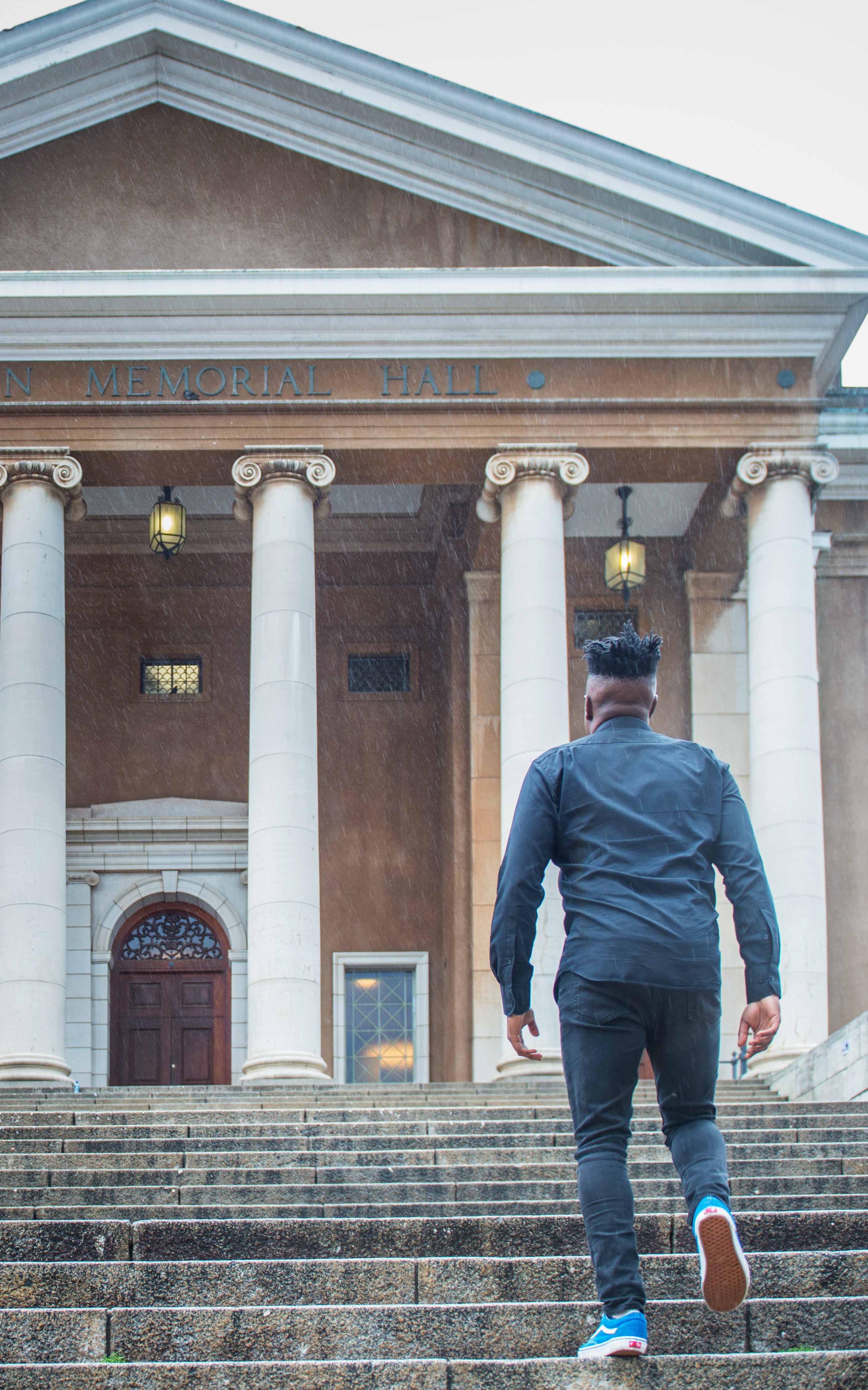 Man walks up stairs towards UCT's main hall