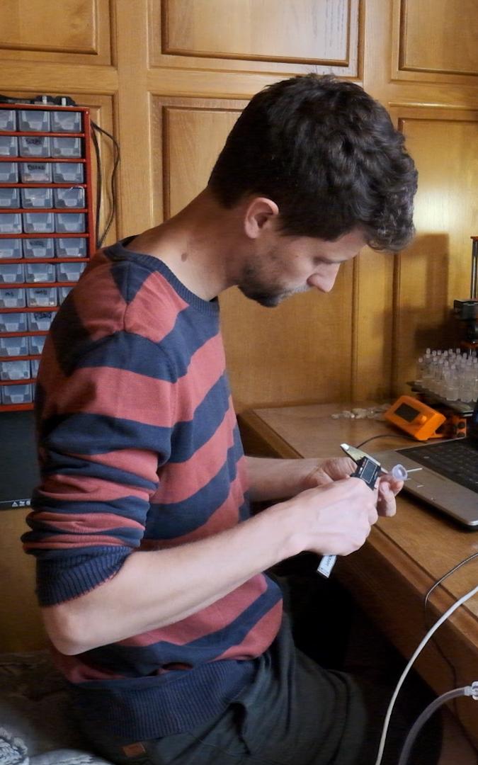 Man making a ventilator.