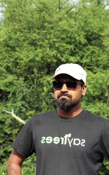 Beautiful News- Man standing in front of trees