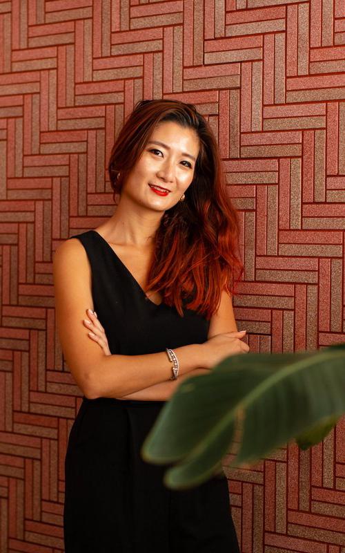 Beautiful News-Woman standing in front of tiled wall