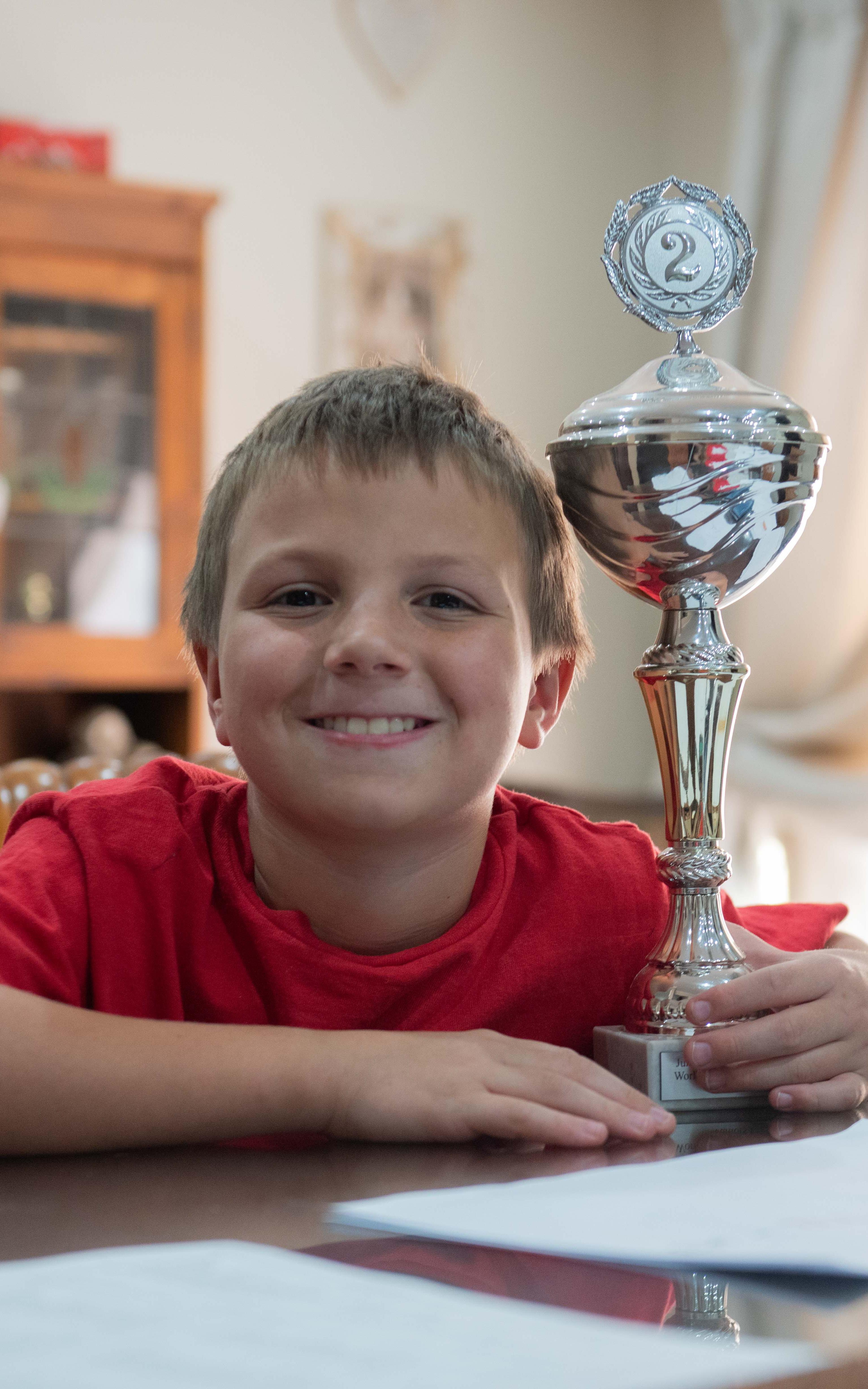 Kid posing with trophy