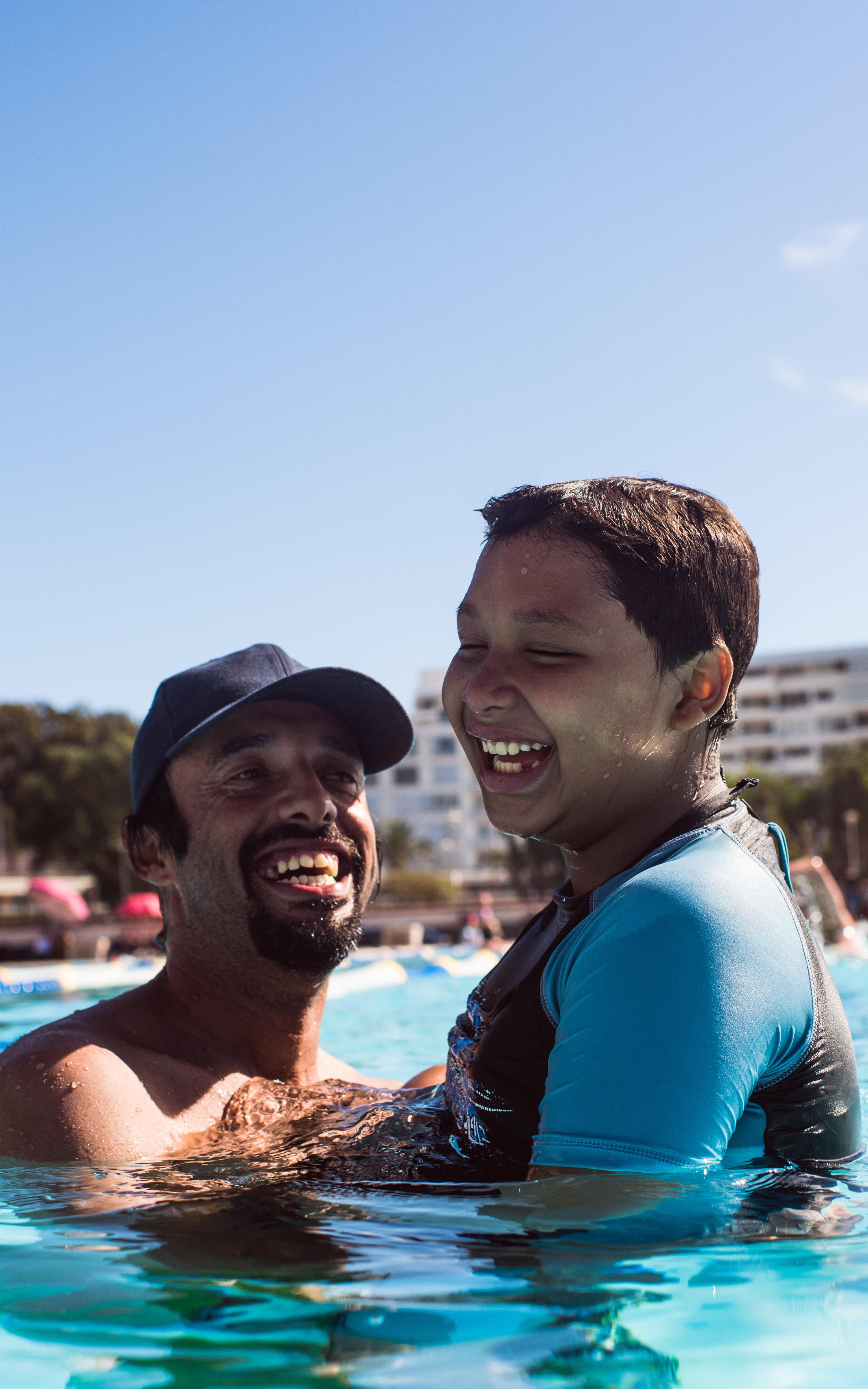 Dad and son in swimming pool