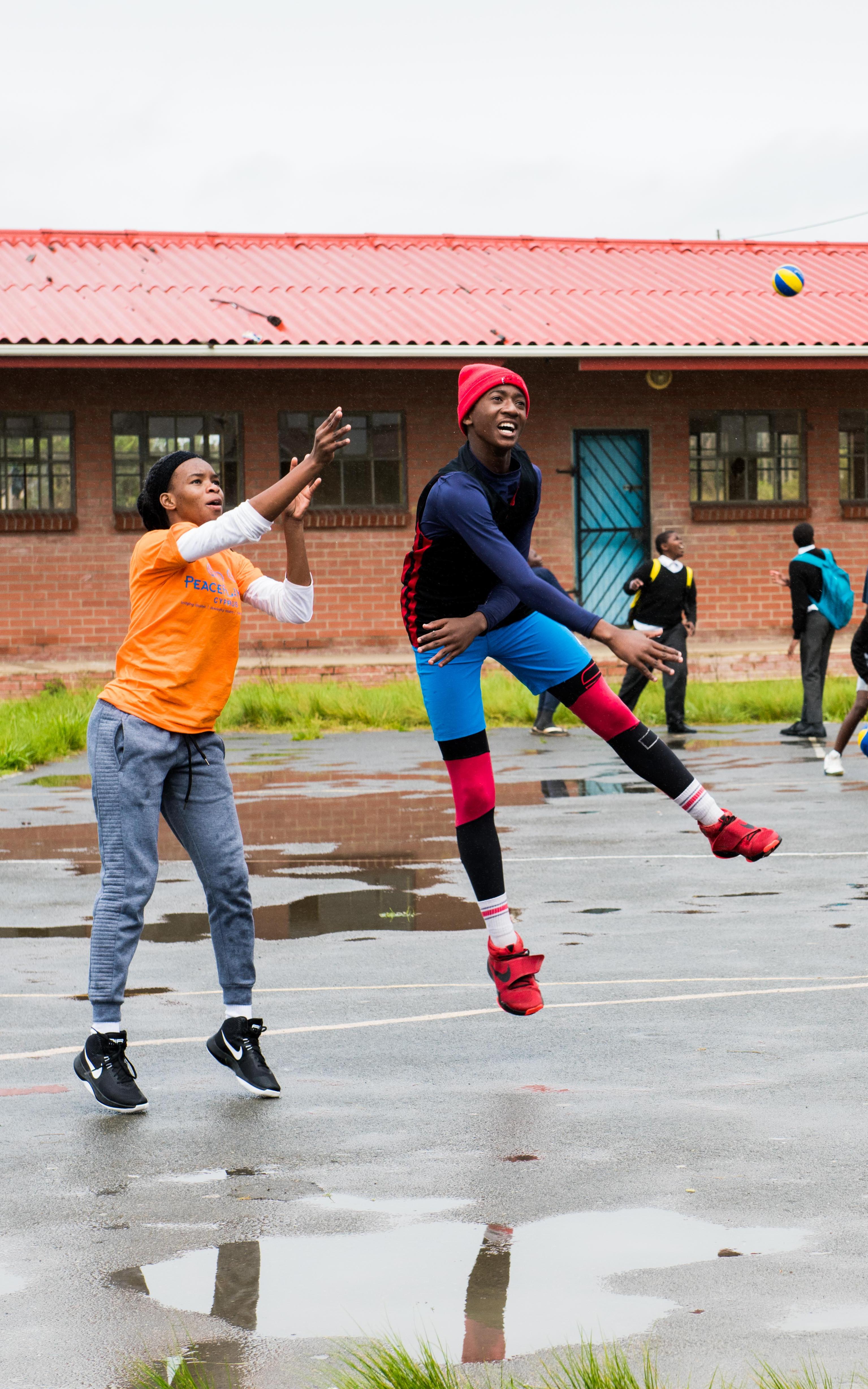 Teens playing basketball