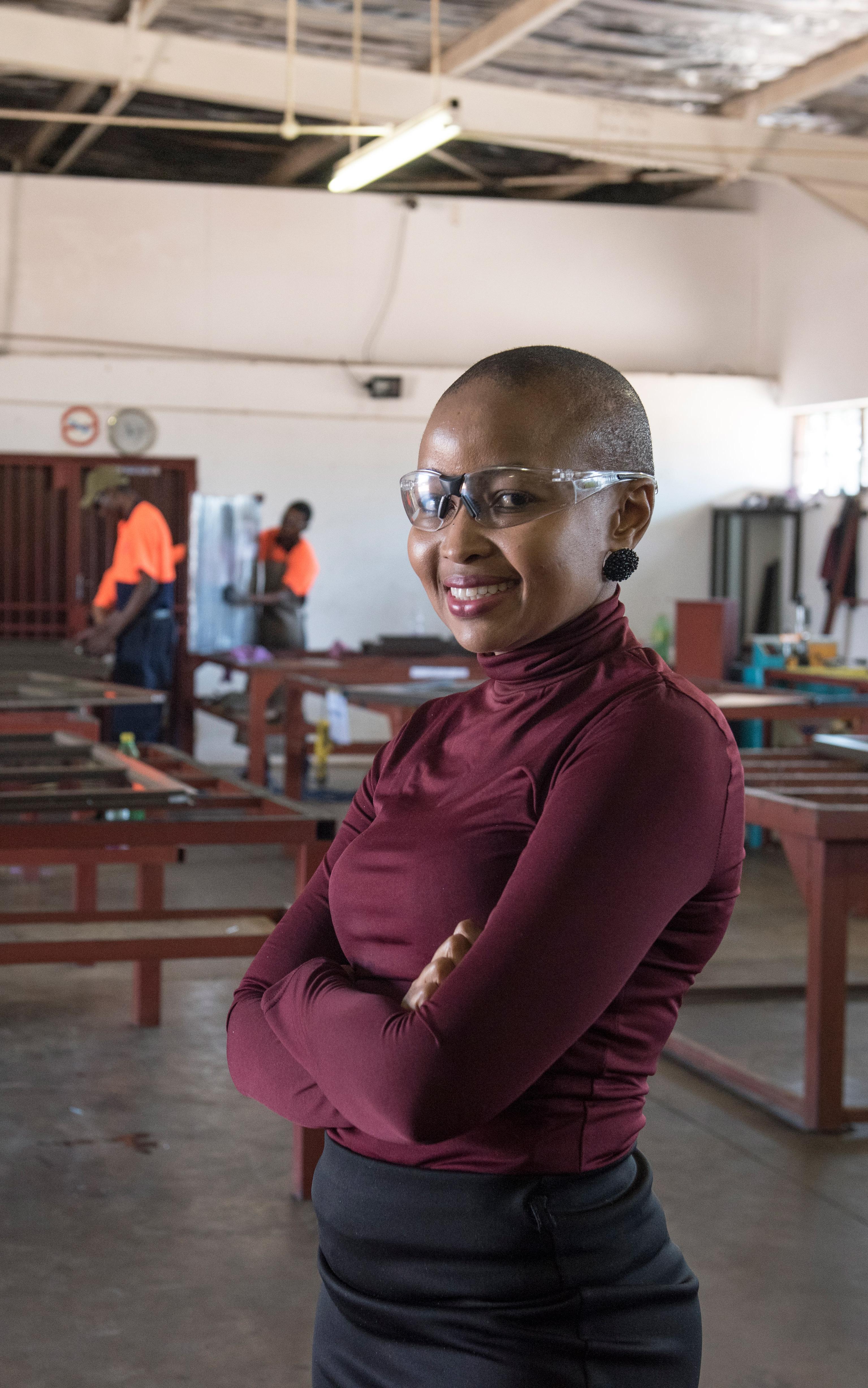 Black woman smiling and wearing protective glasses
