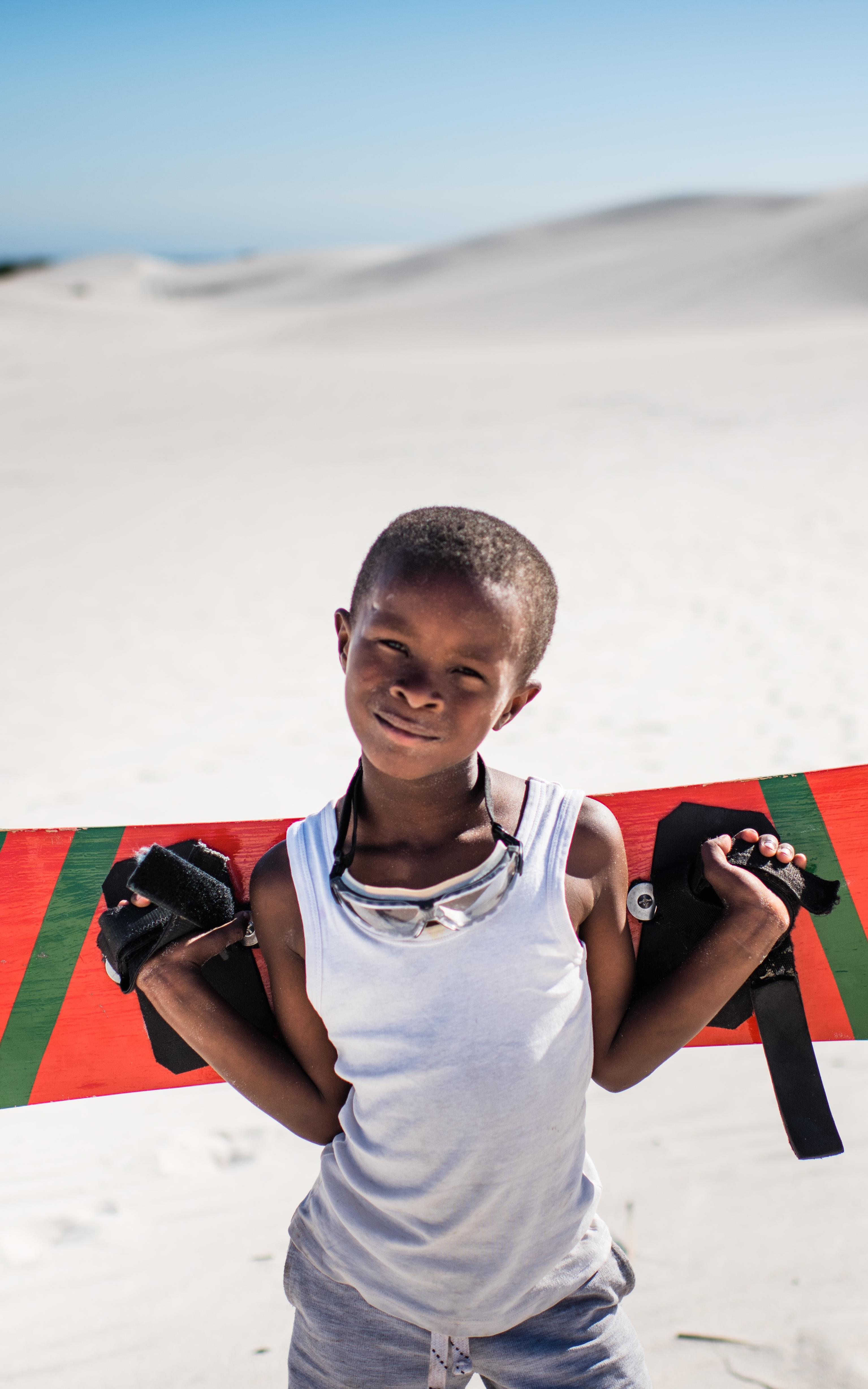 Black boy posing with sandboard