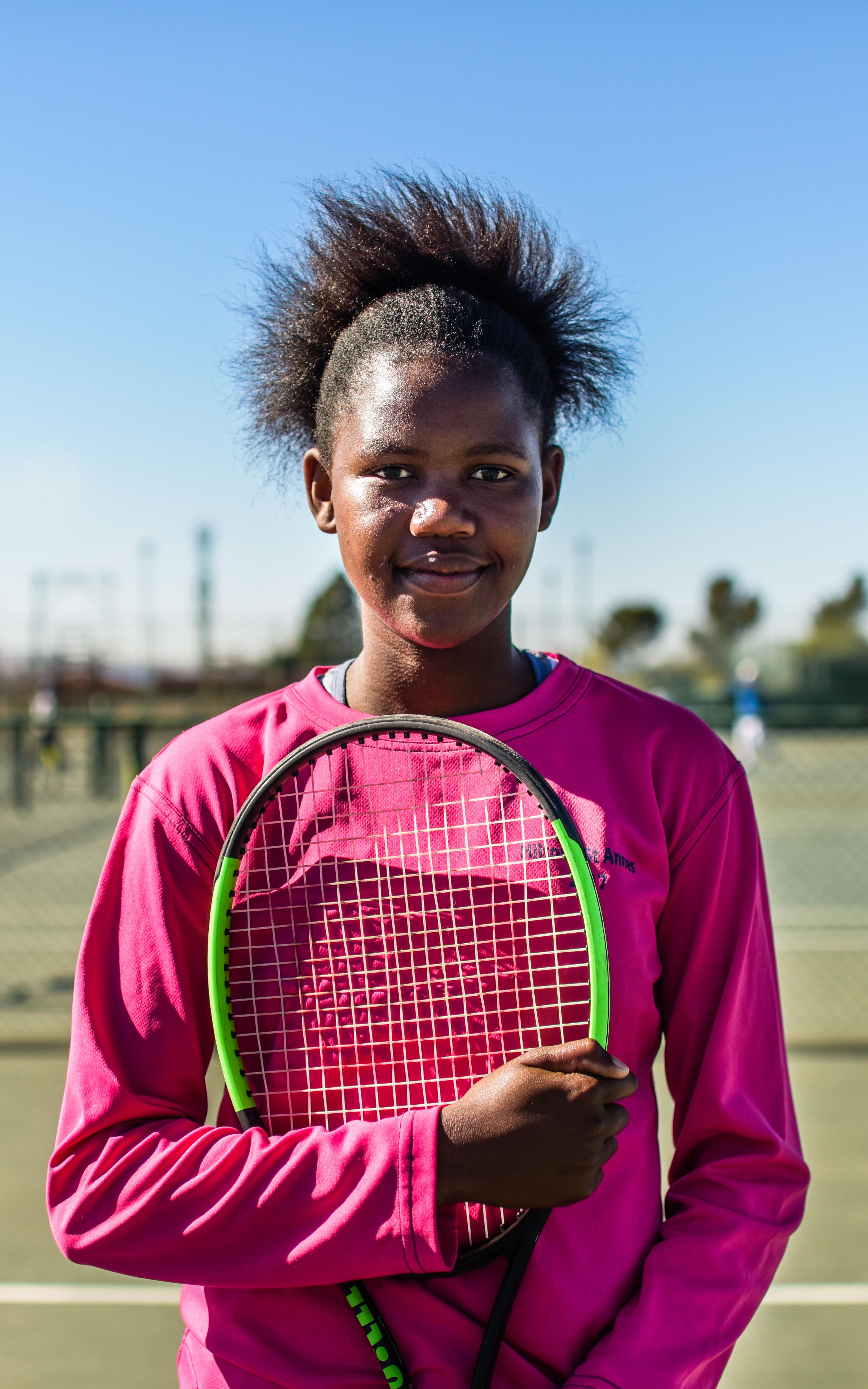 Girl holding tennis racket