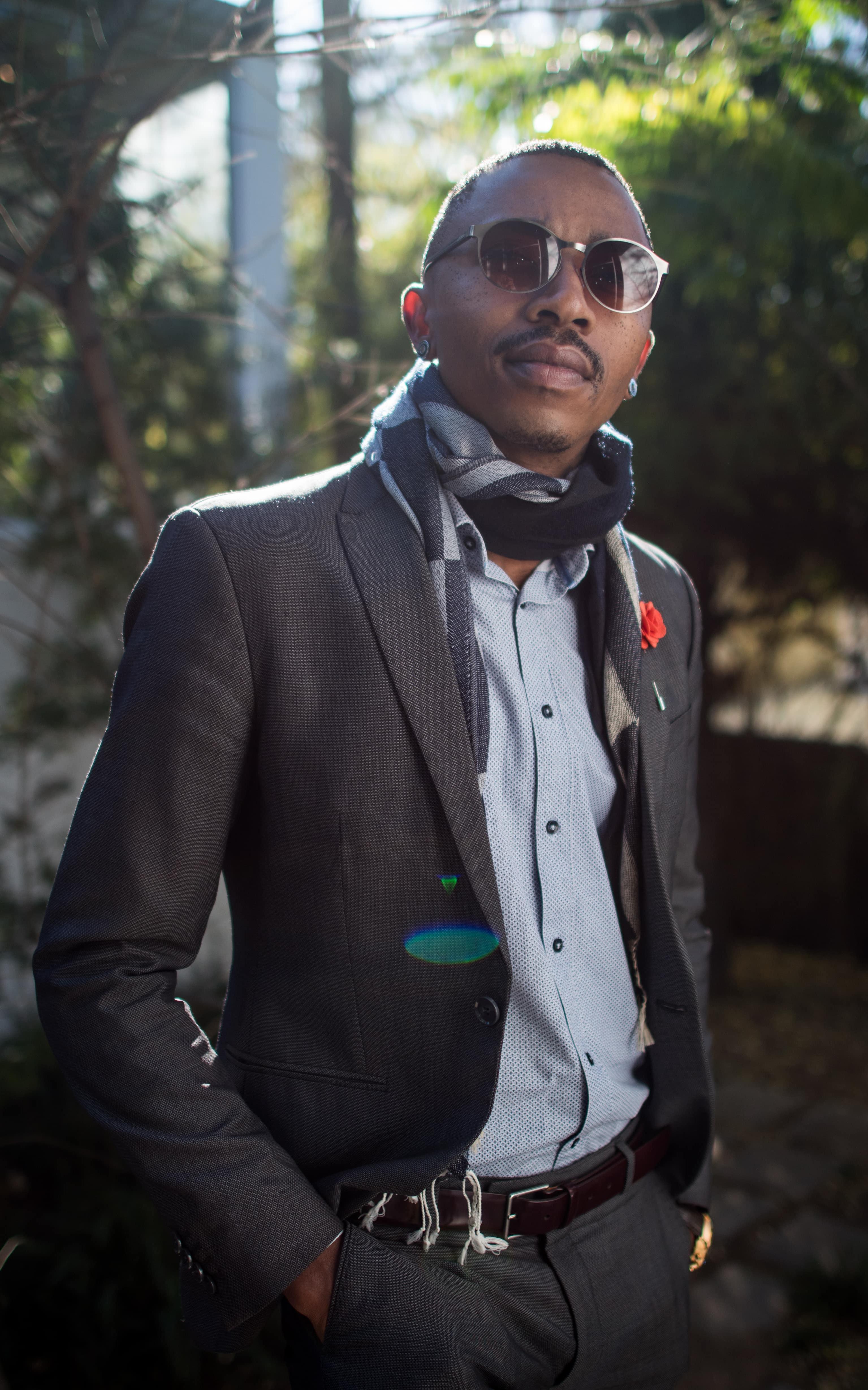 Fashionably dressed black man smiling at camera