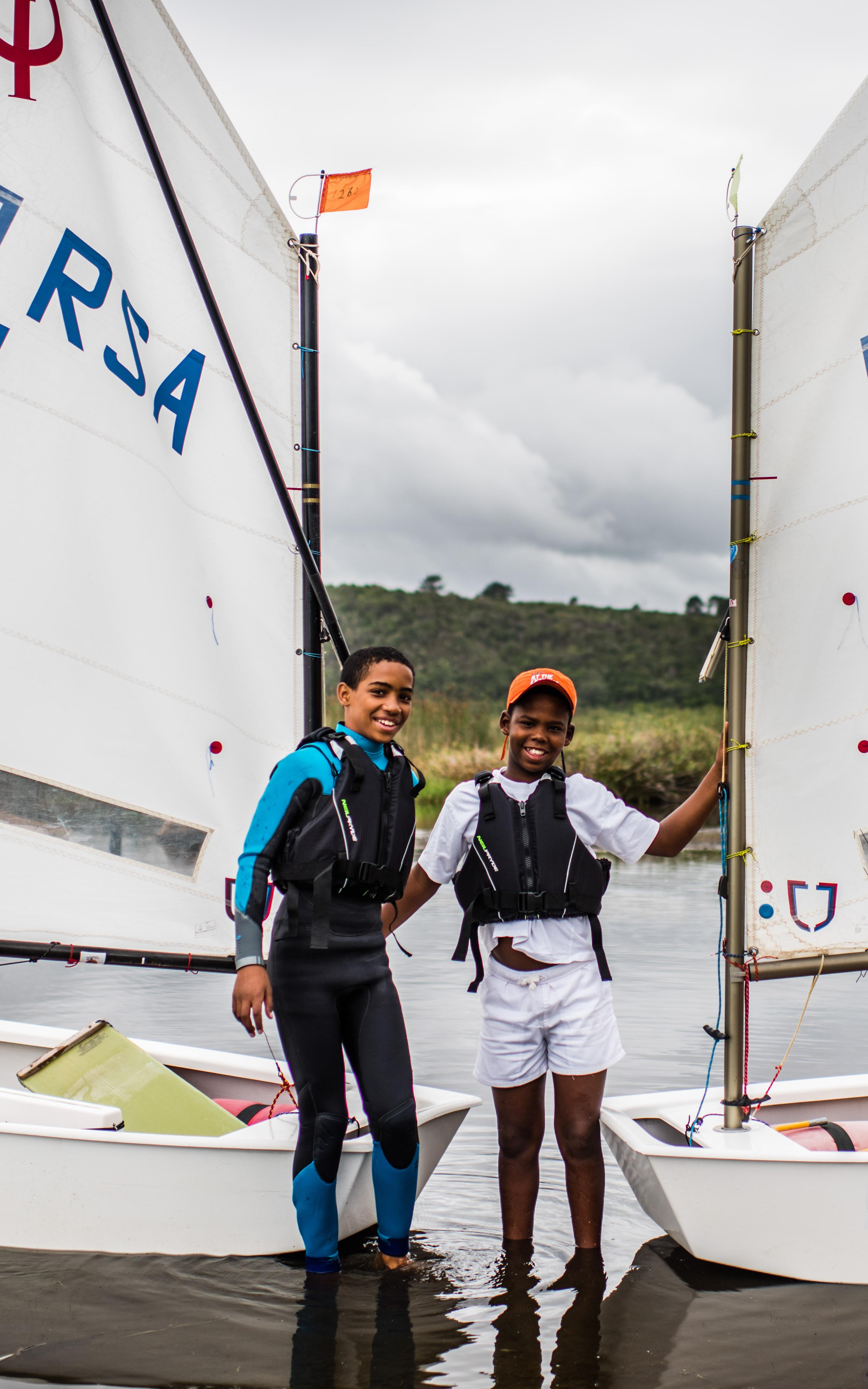 to boys, smiling on a boat