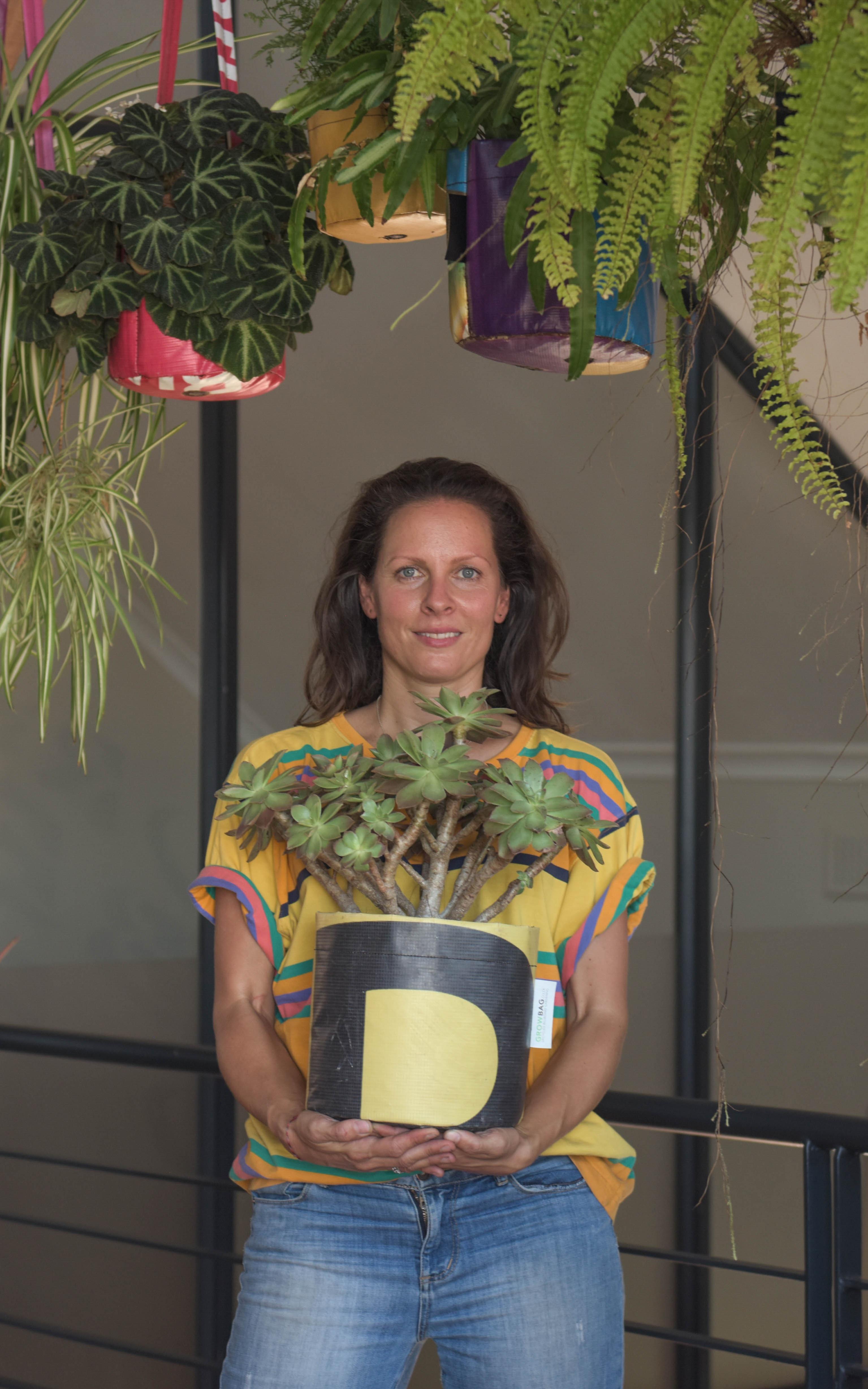 woman holding a plant
