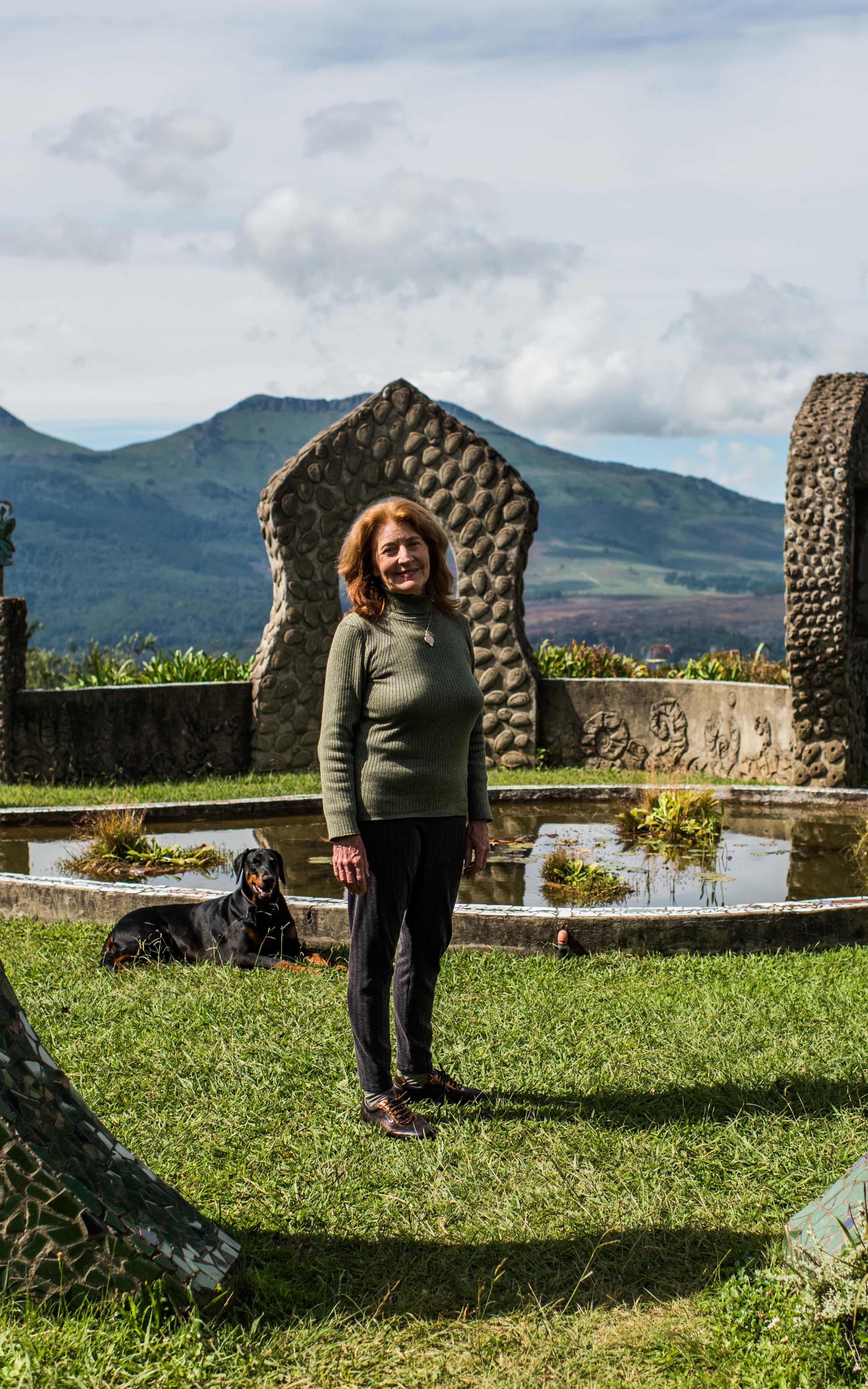 Woman stands in the middle of an ecological shrine