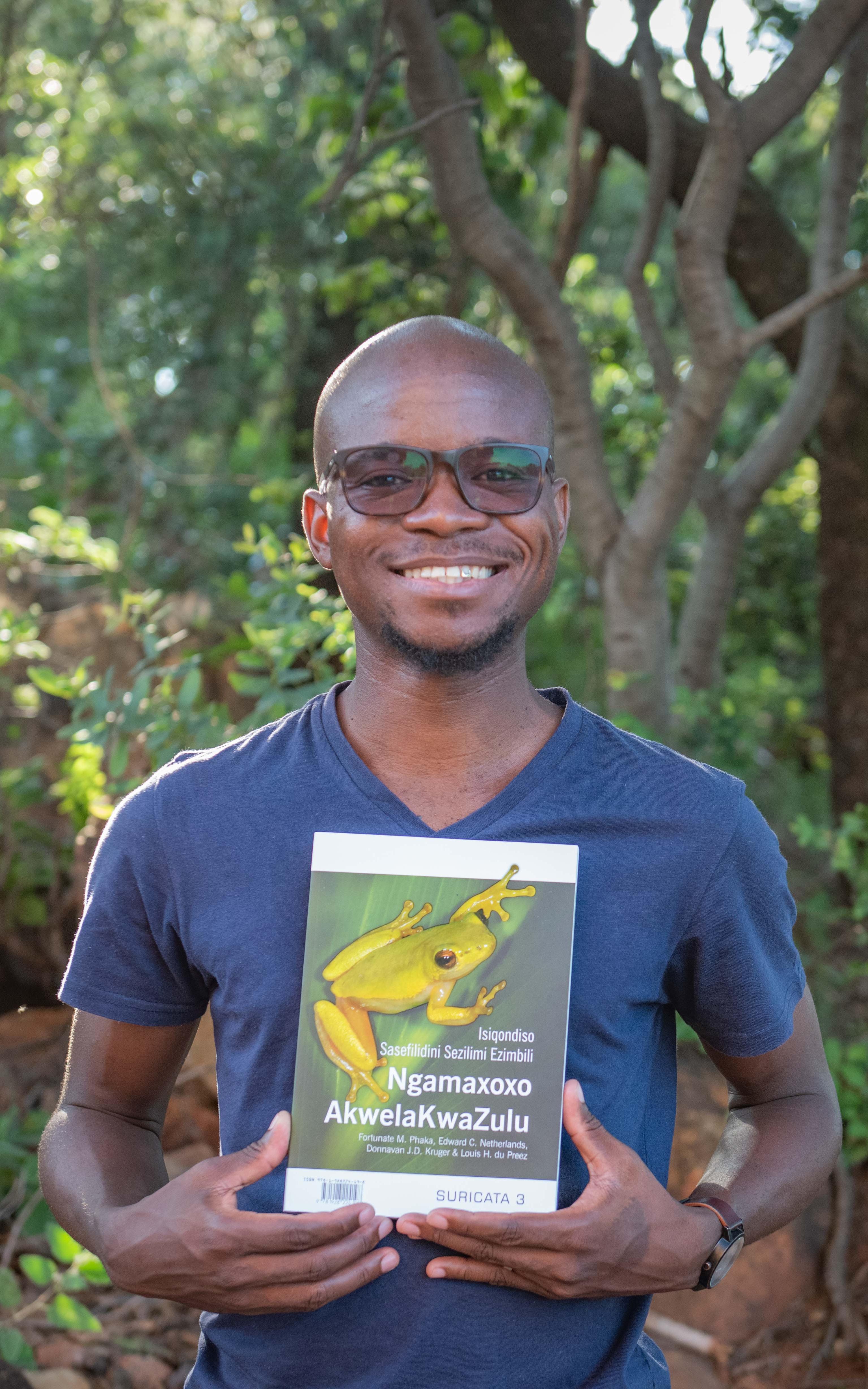 Black man holding a book