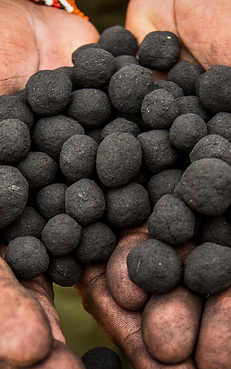 Beautiful News - A person's hands hold seedballs in Kenya