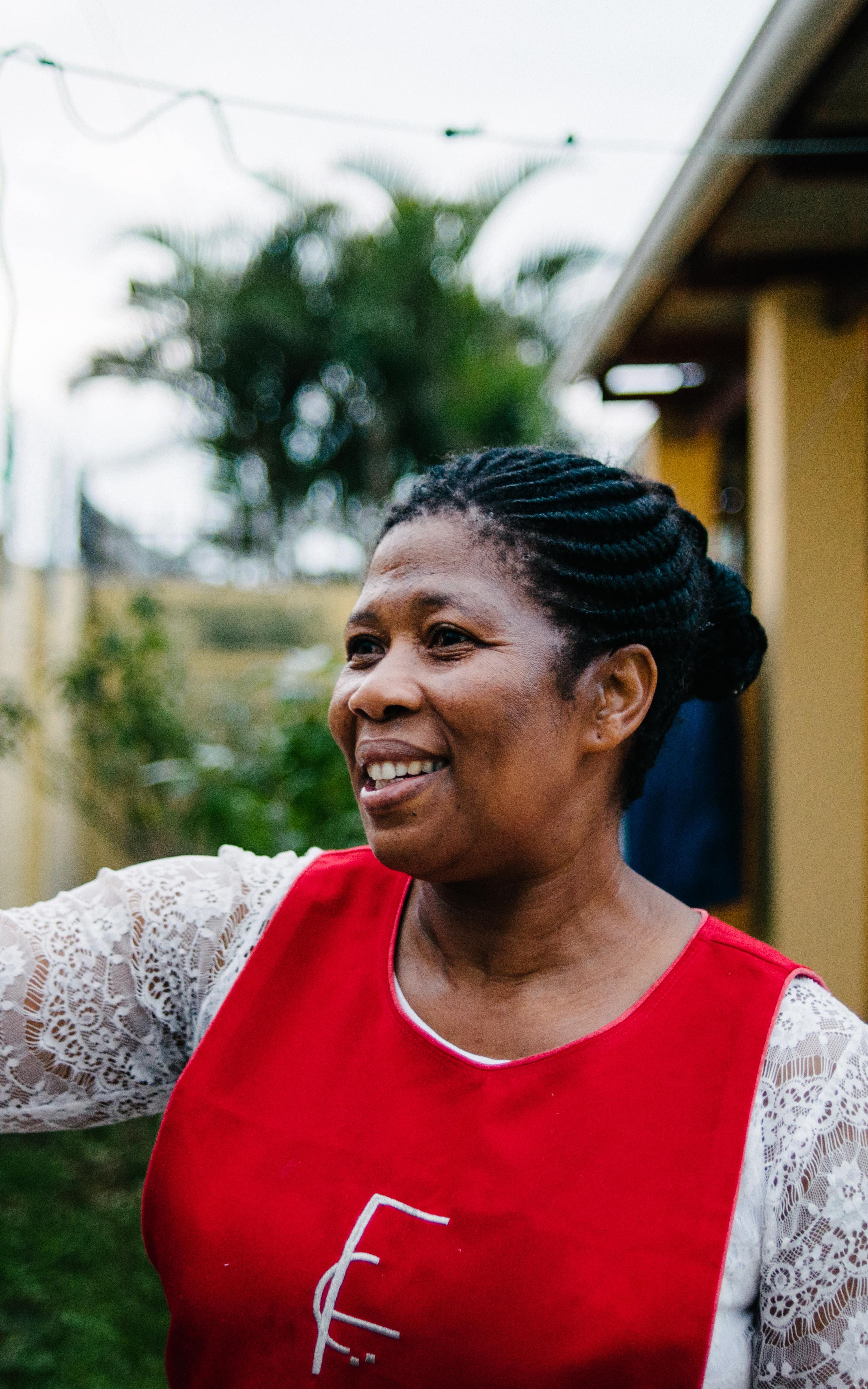 Black woman smiling and waving