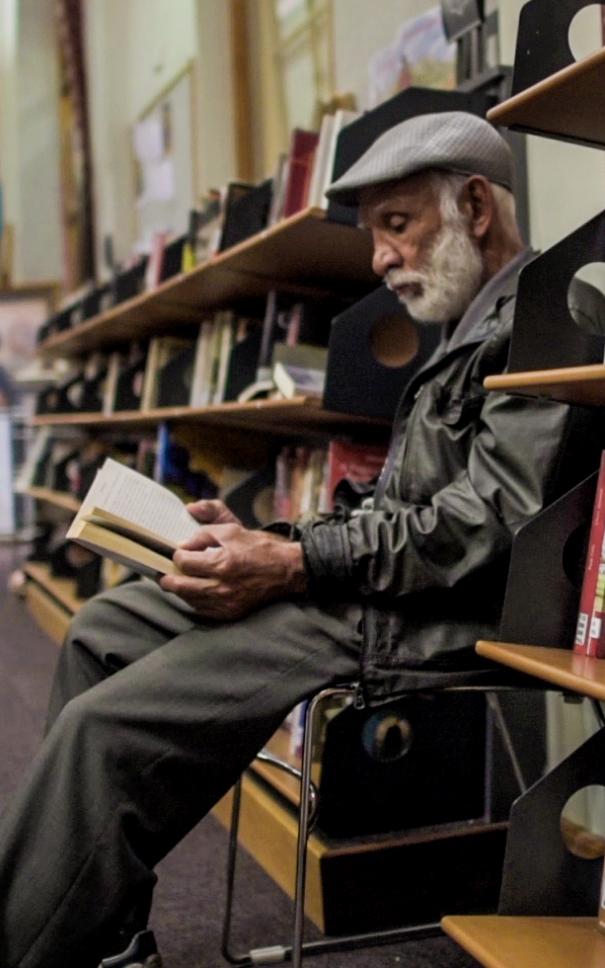 Man reading in library.