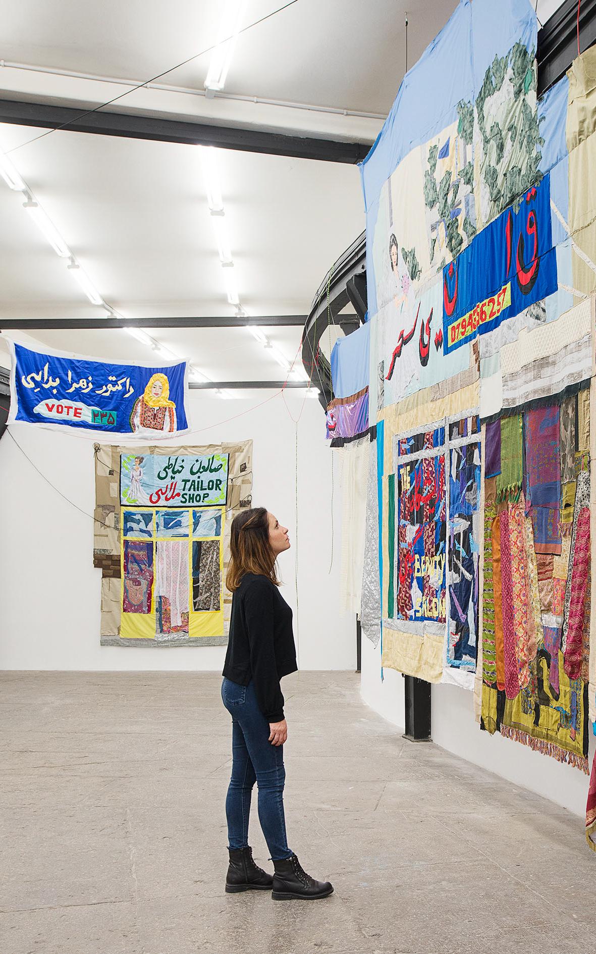 Beautiful News- Woman admires textiles display