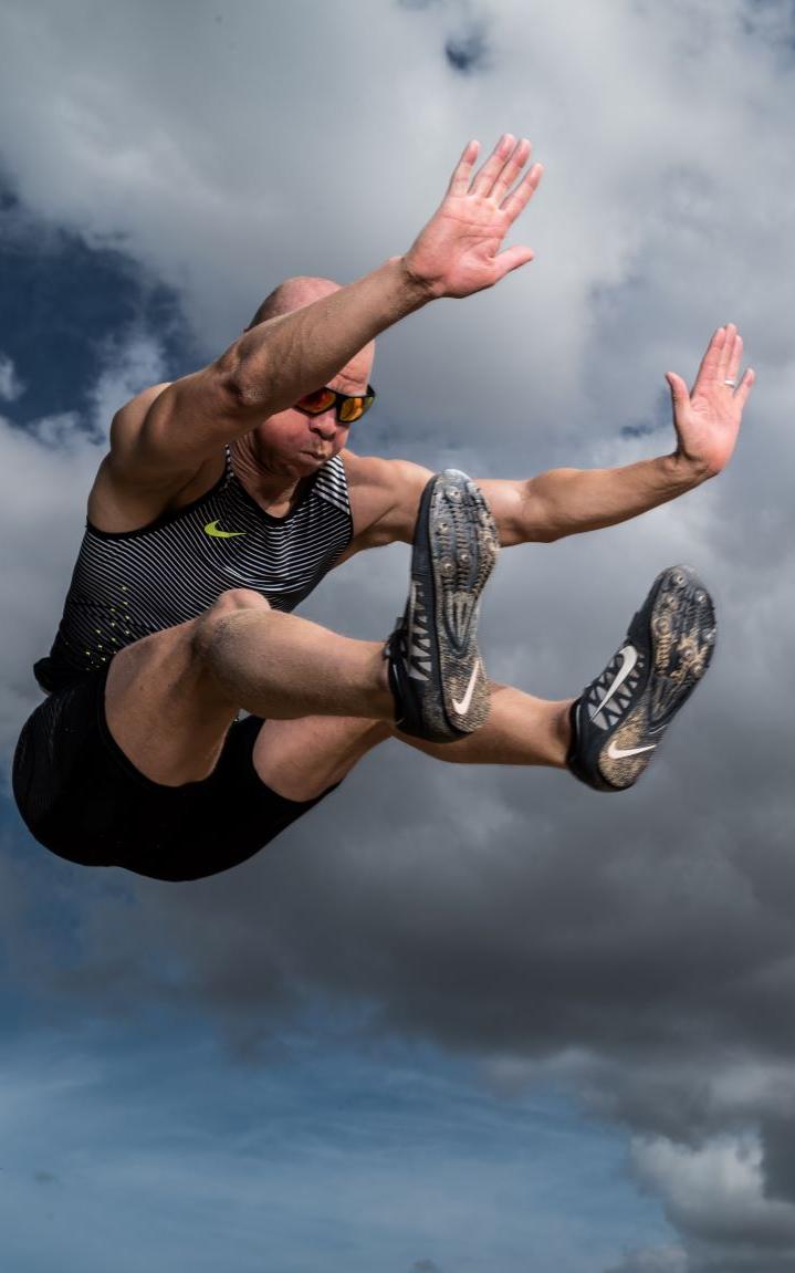 Blind long jumper in the air.