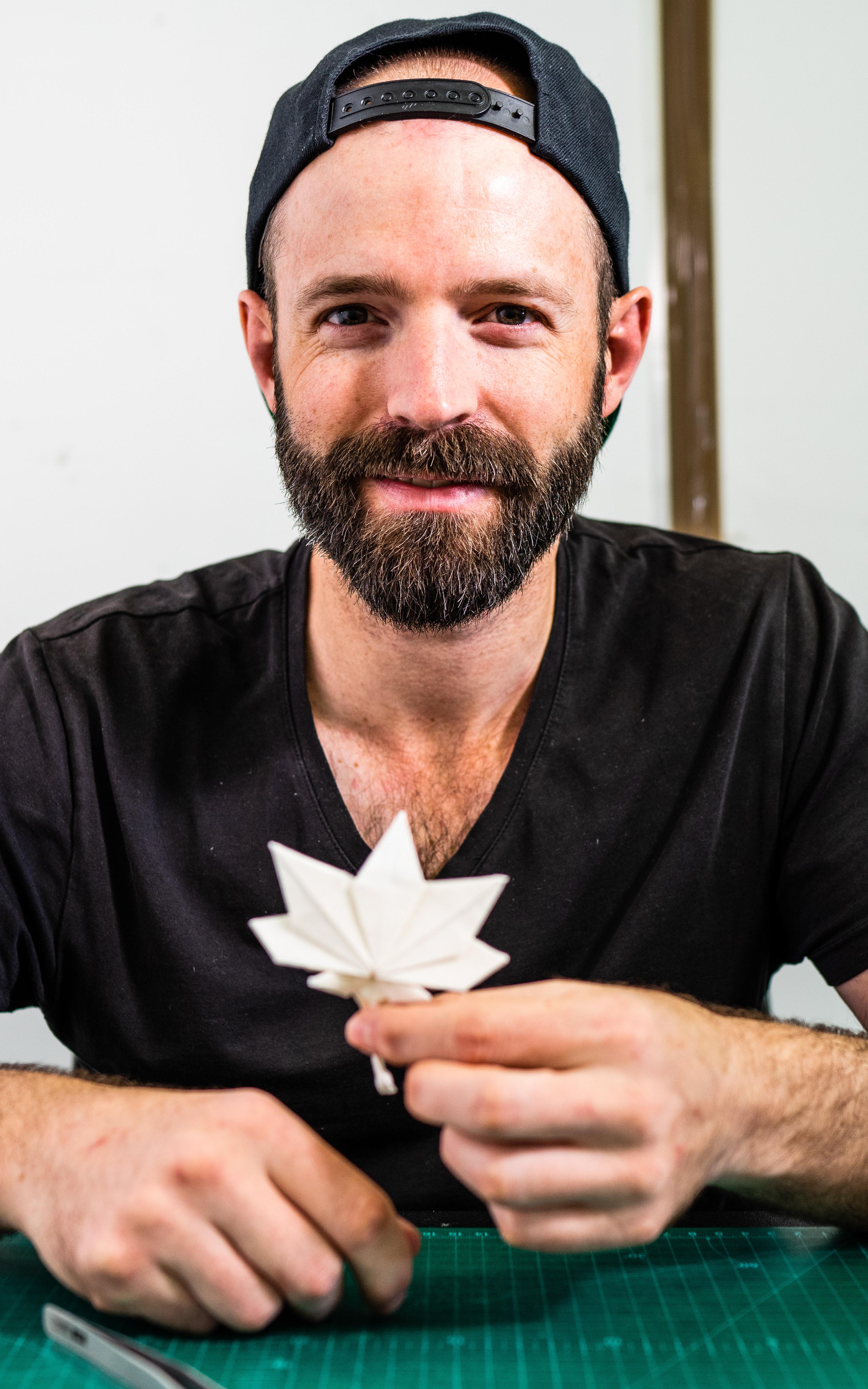 Man posing with origami