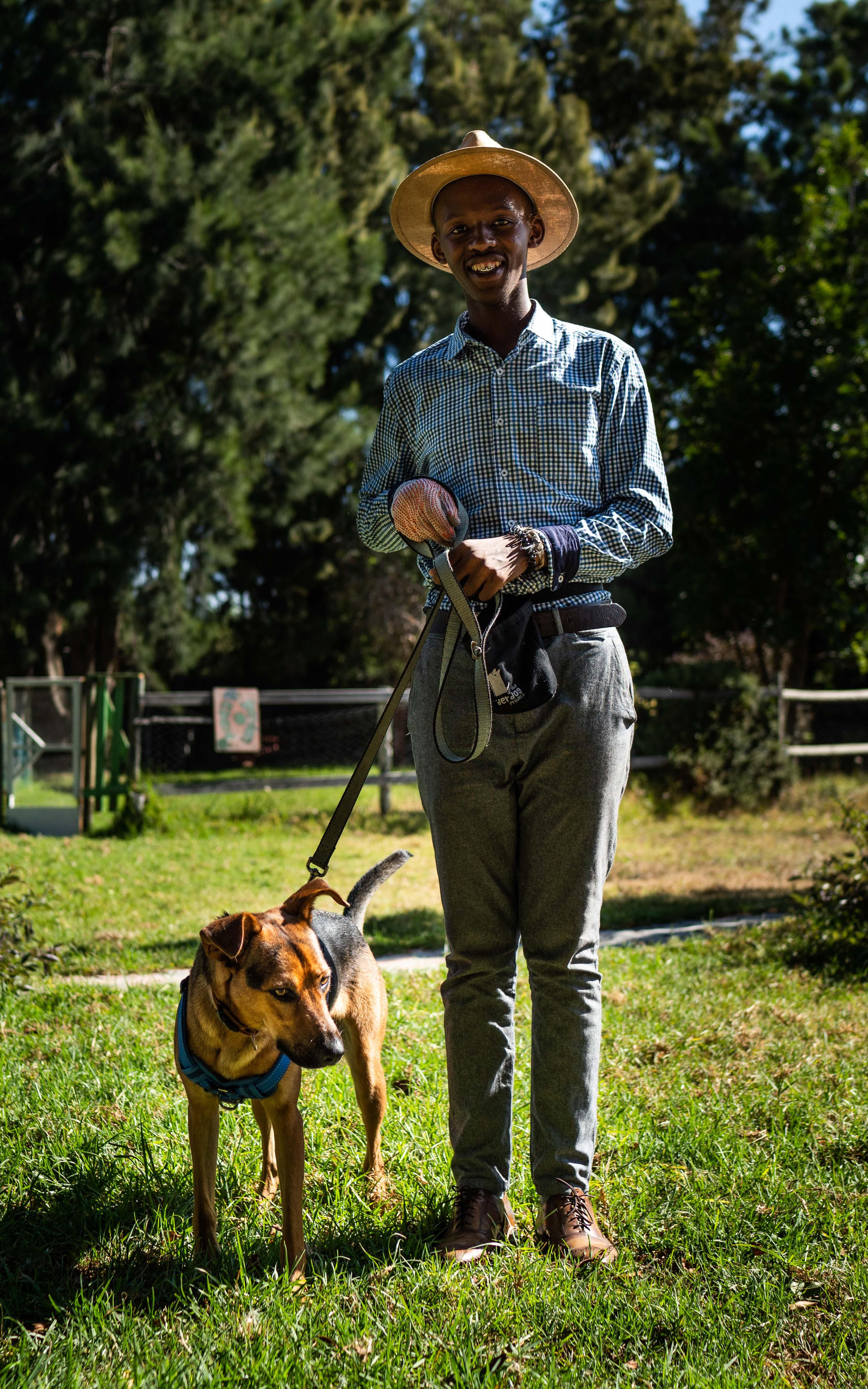 Boy with dog on lead. 