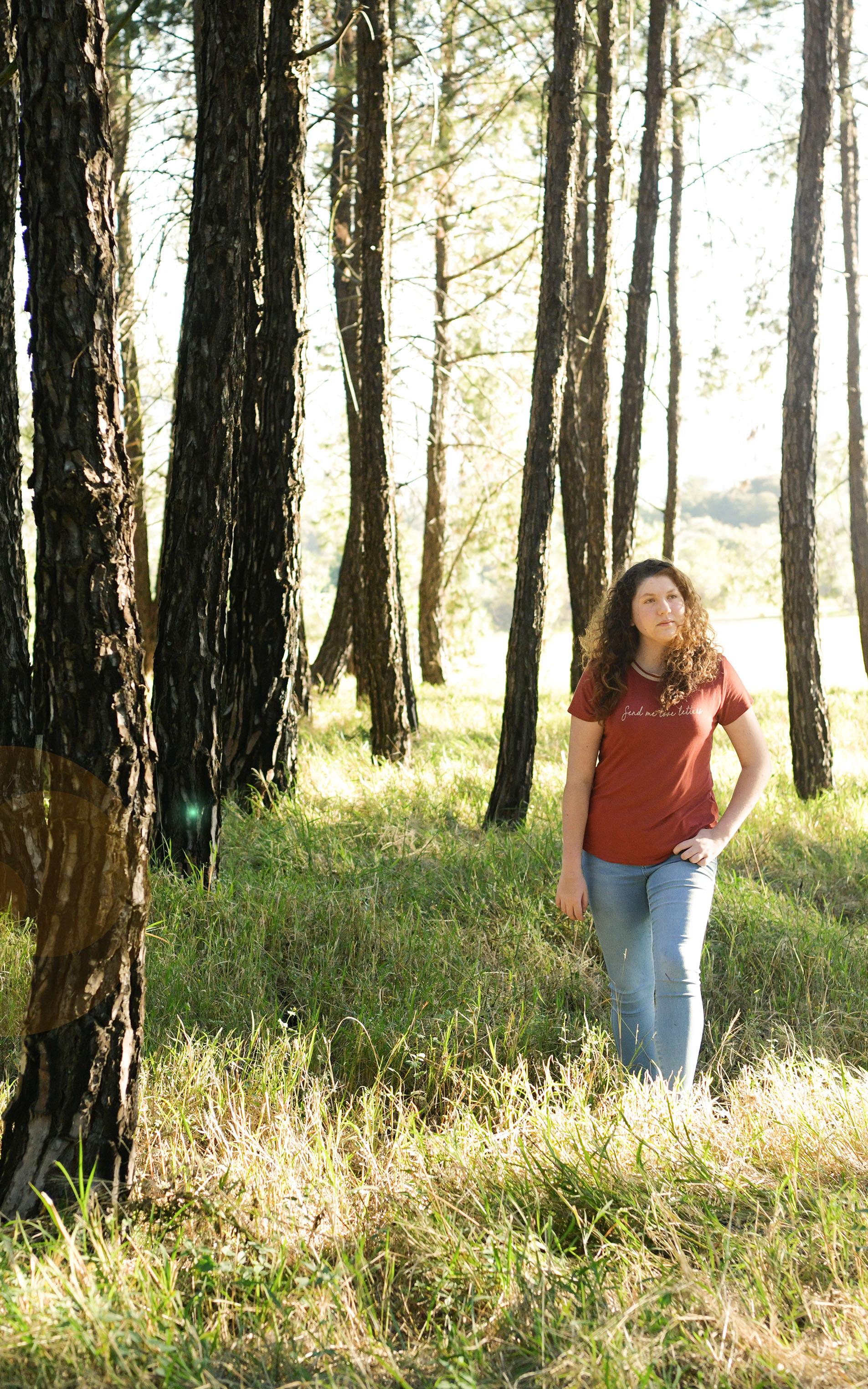 Beautiful News - Teen Poet Jess Robus standing in forest with tall green grass