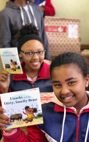 Beautiful News - Children of Book Dash holding up their books and smiling