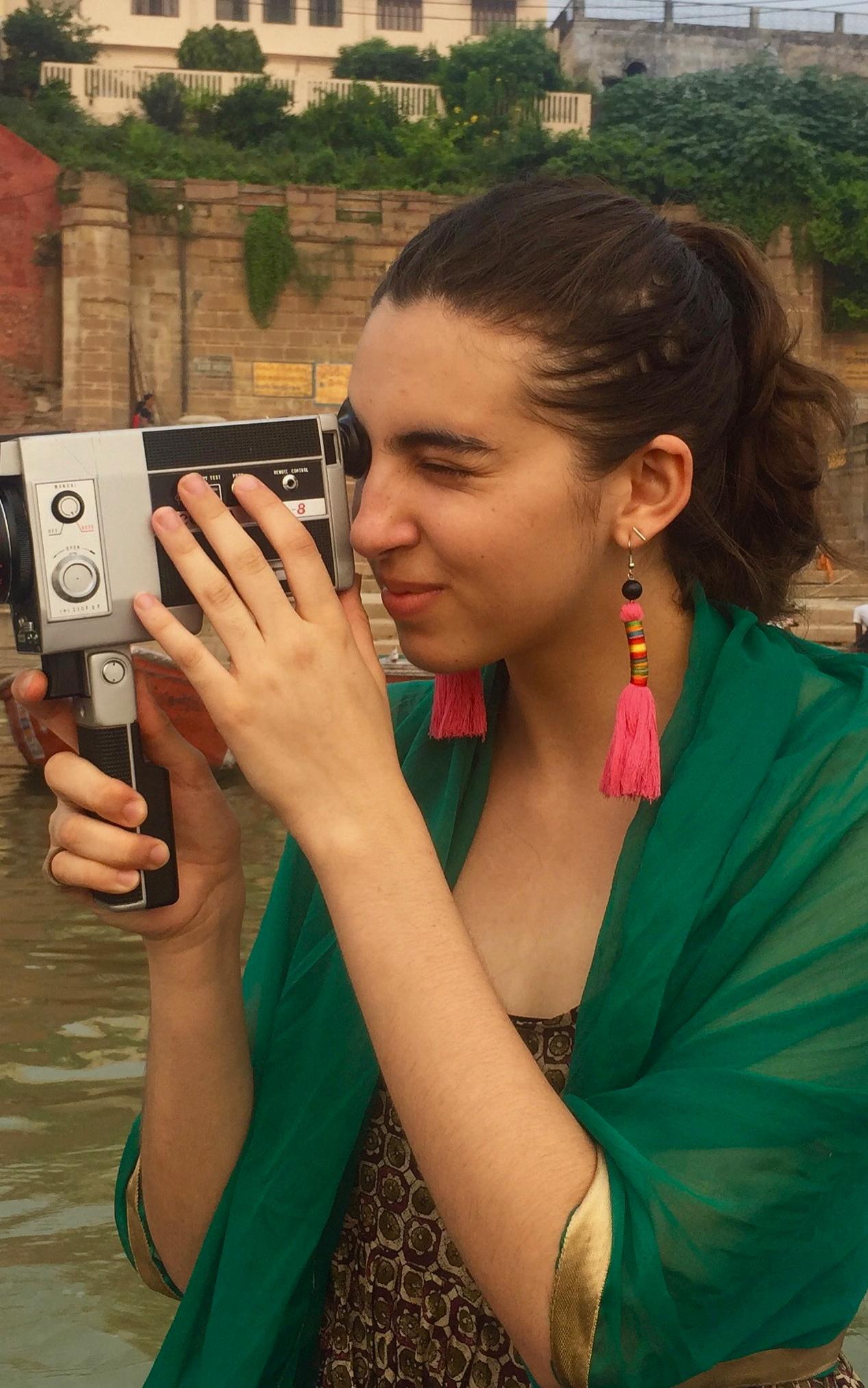Woman looking through vintage video camera