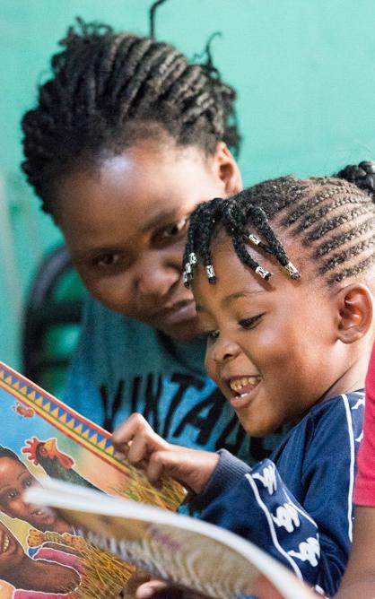 Kids looking at a book.