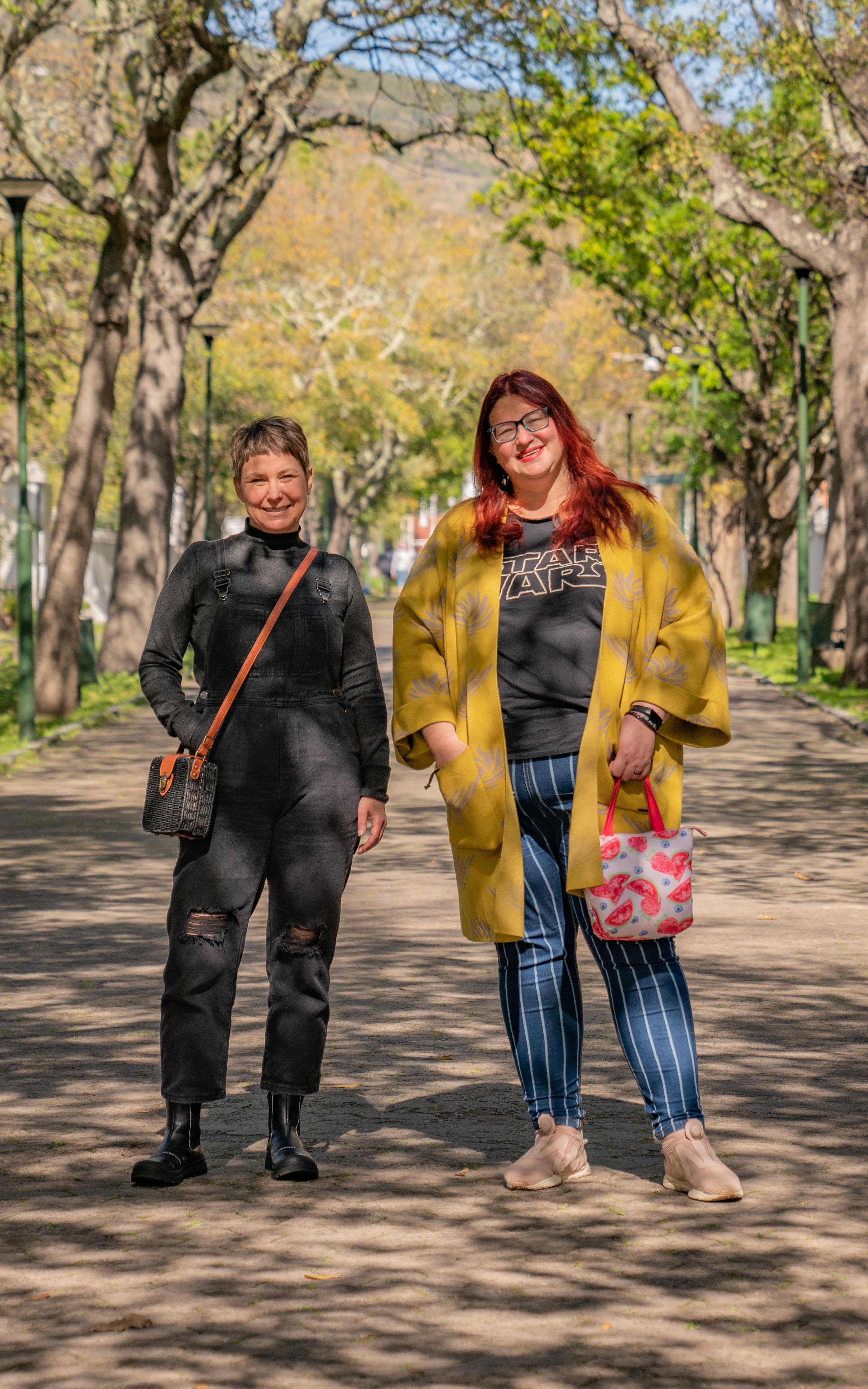 Beautiful News-Two women standing side by side on a walkway 