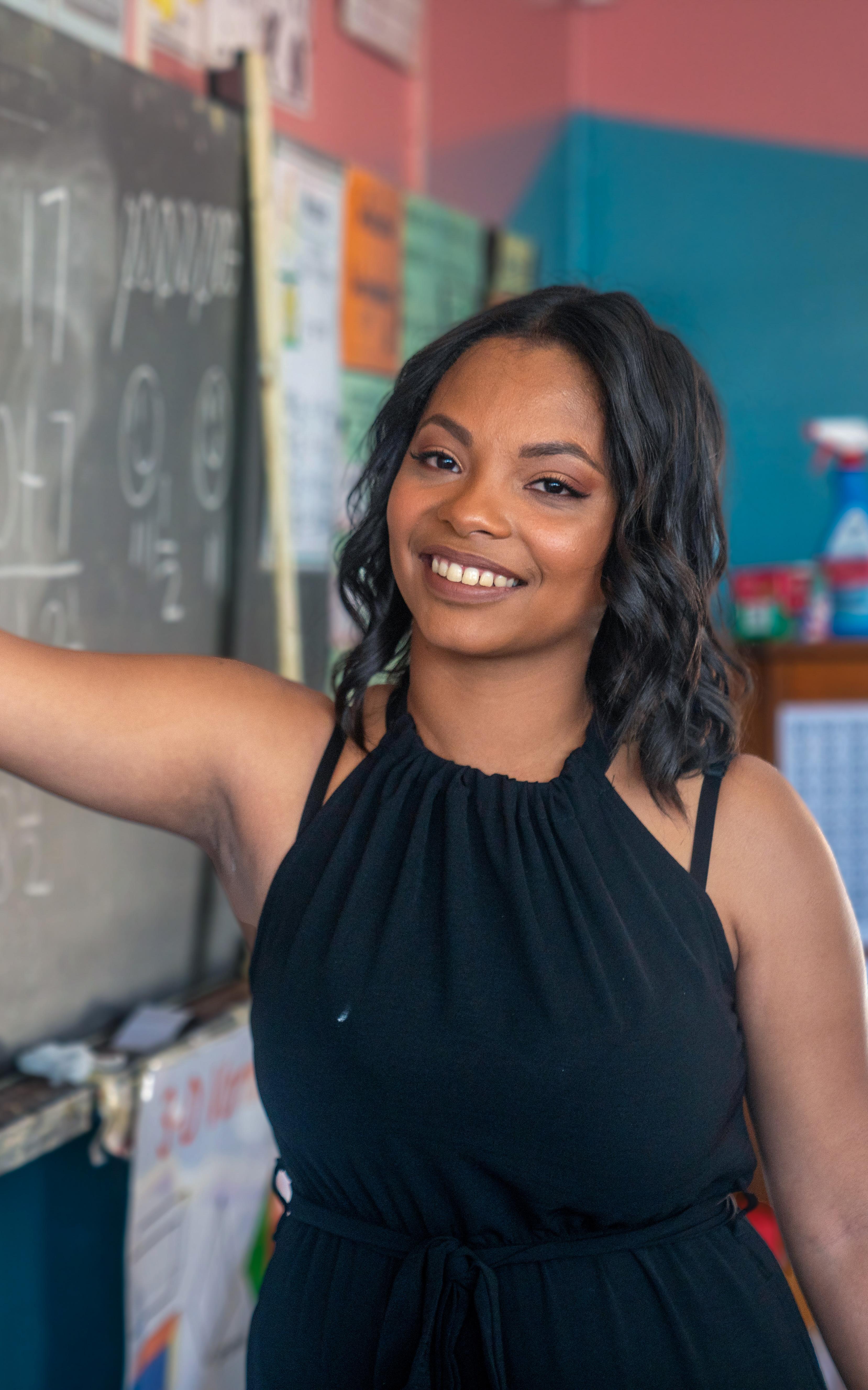 Cape Town teacher Keachell Jeffery writes out a maths sum on a classroom chalkboard