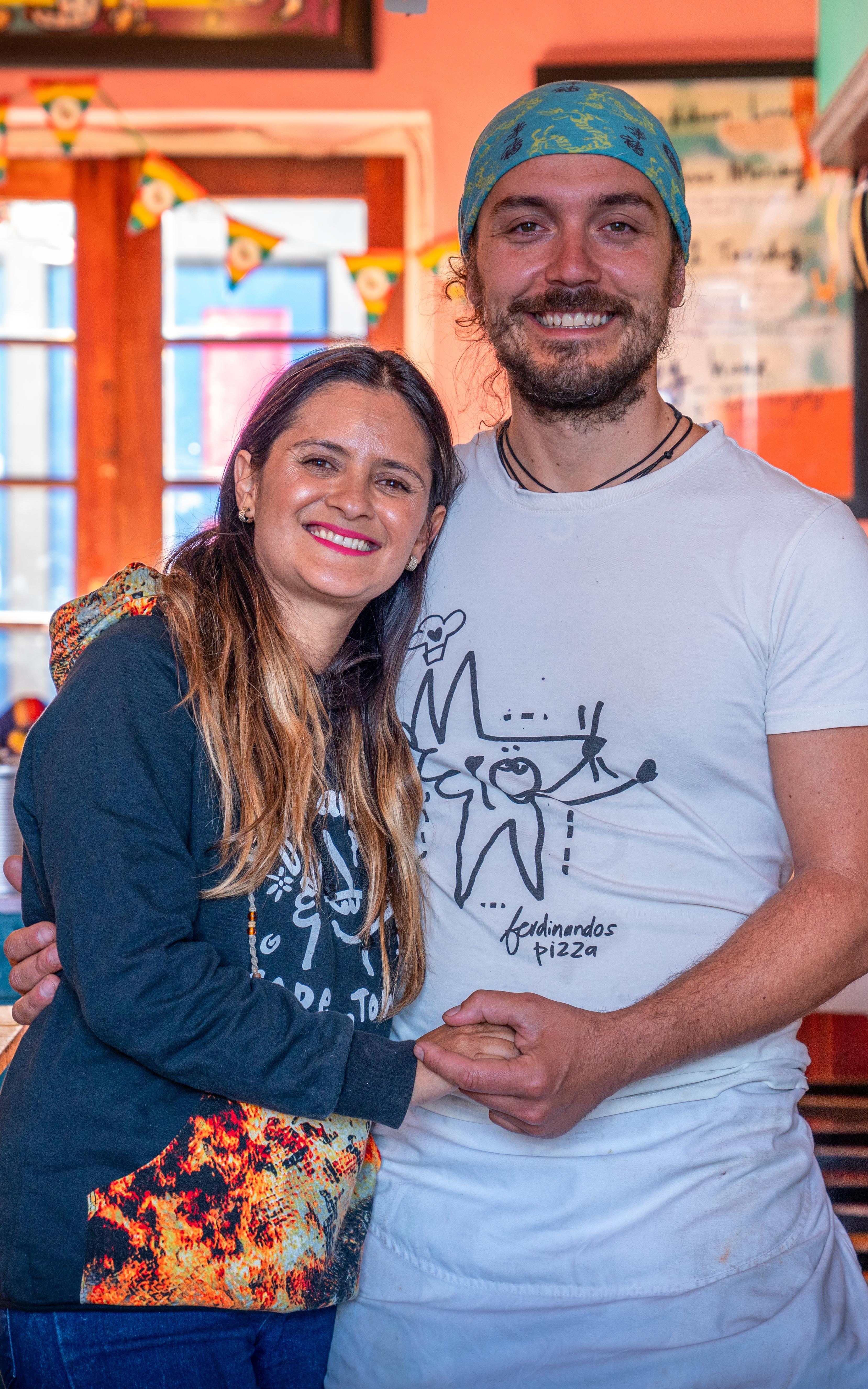 Beautiful News-Couple holding hands in a restaurant kitchen.