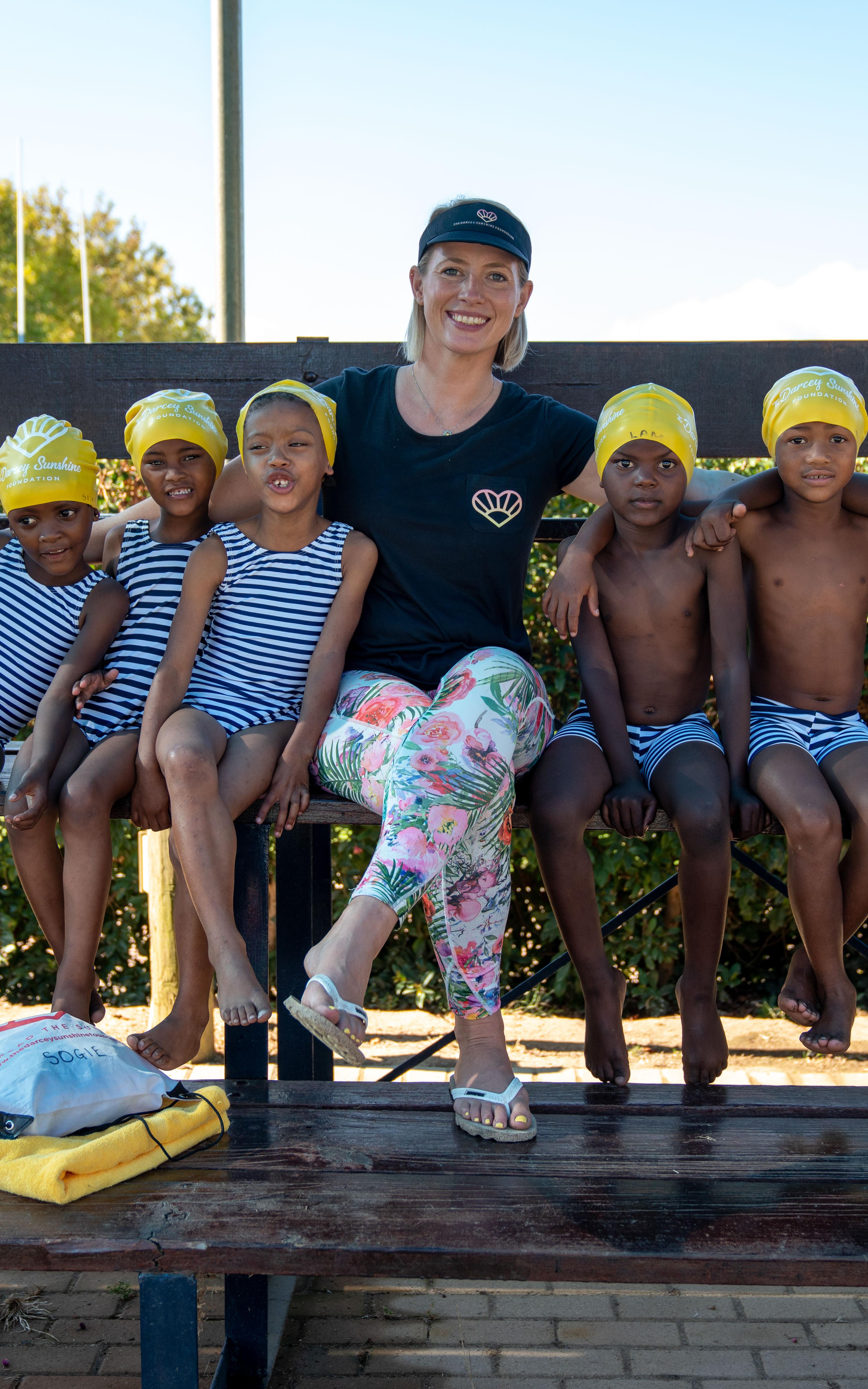 Beautiful News-Woman with her swimming students.