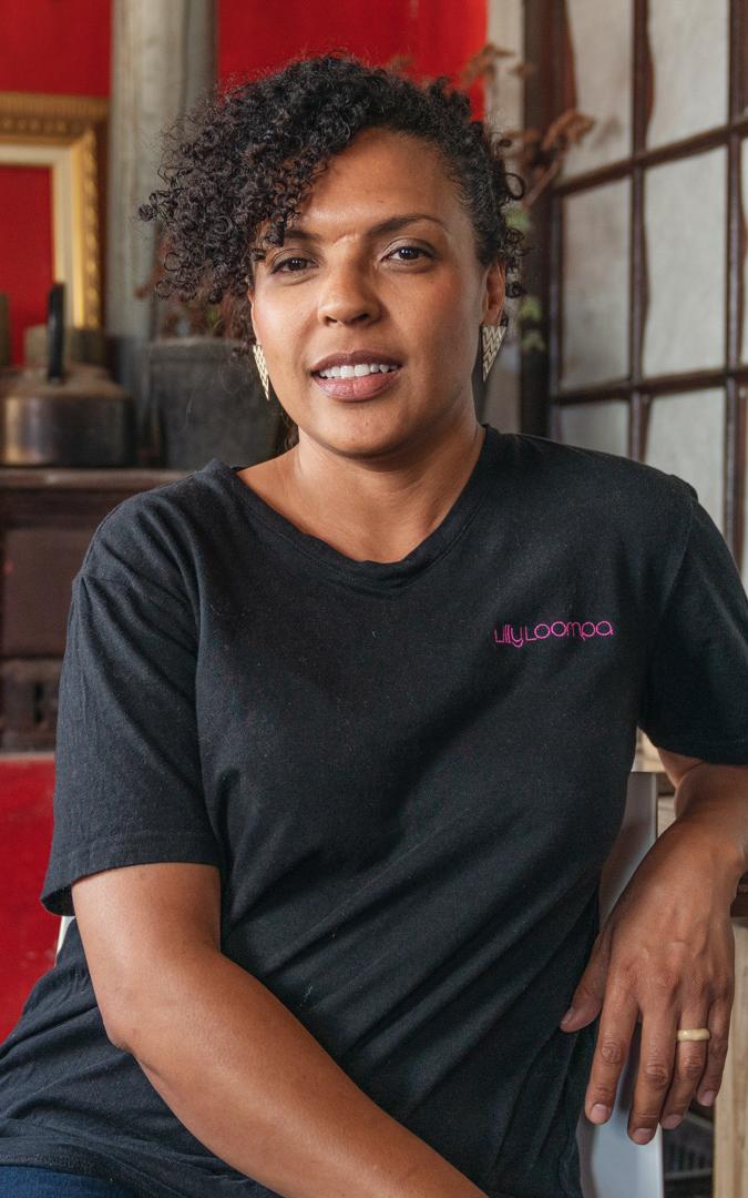 Coloured woman smiling into camera.