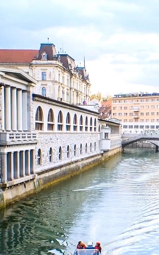 Beautiful News - Image of people on a boat travelling through a water canal in Ljubljana, Slovenia.