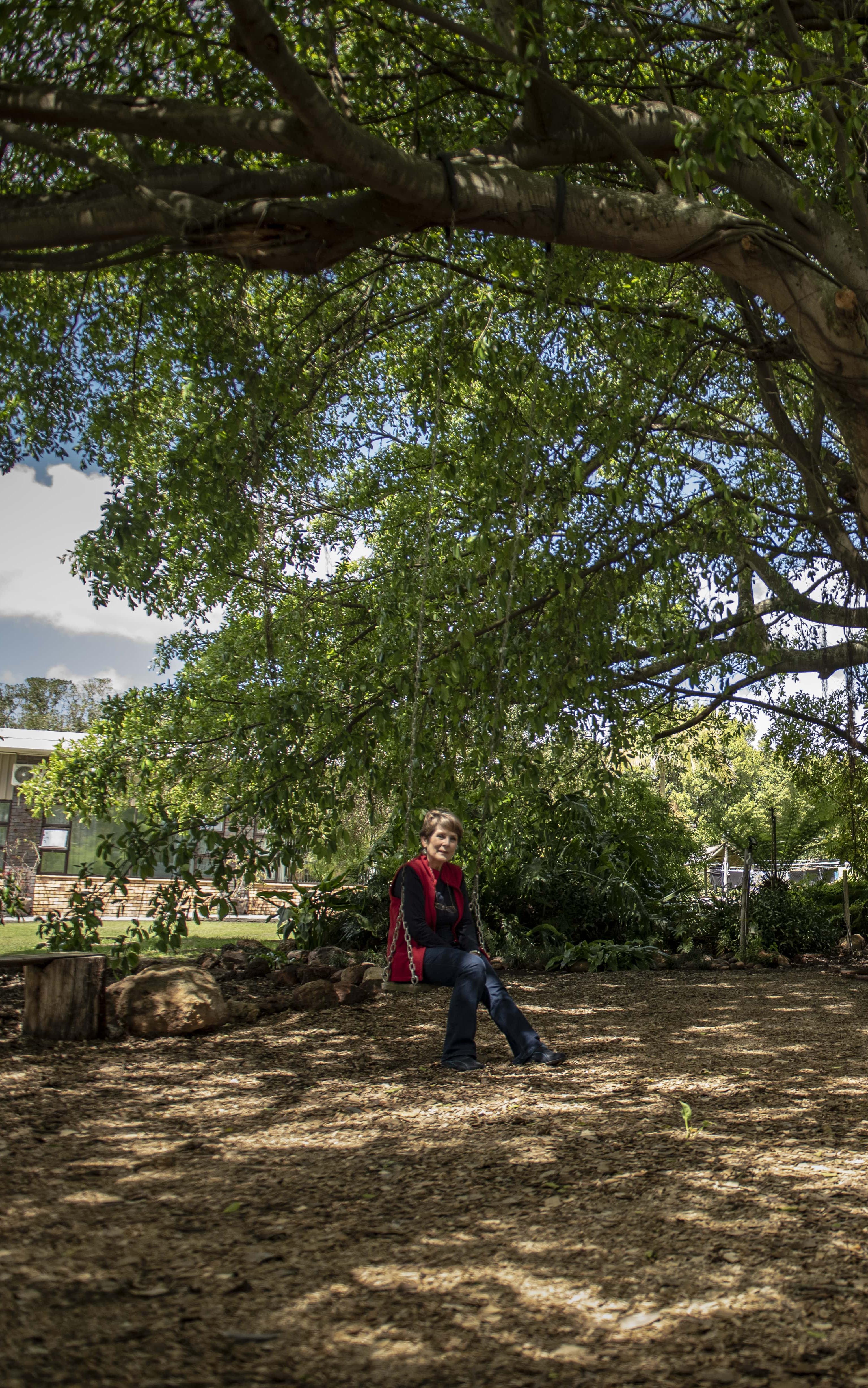 Woman sitting by a tree