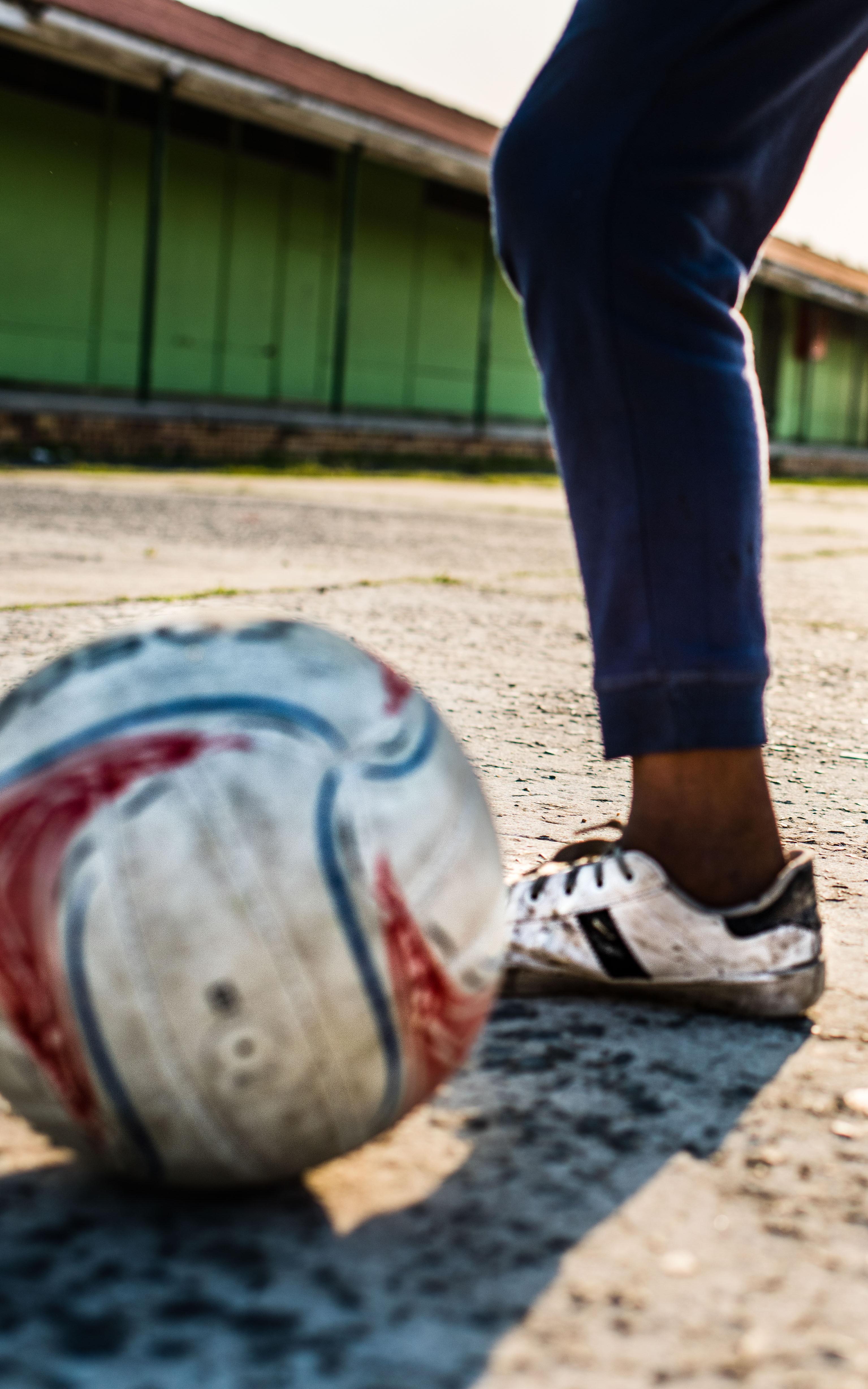 Soccer ball and boy wearing soccer shoes