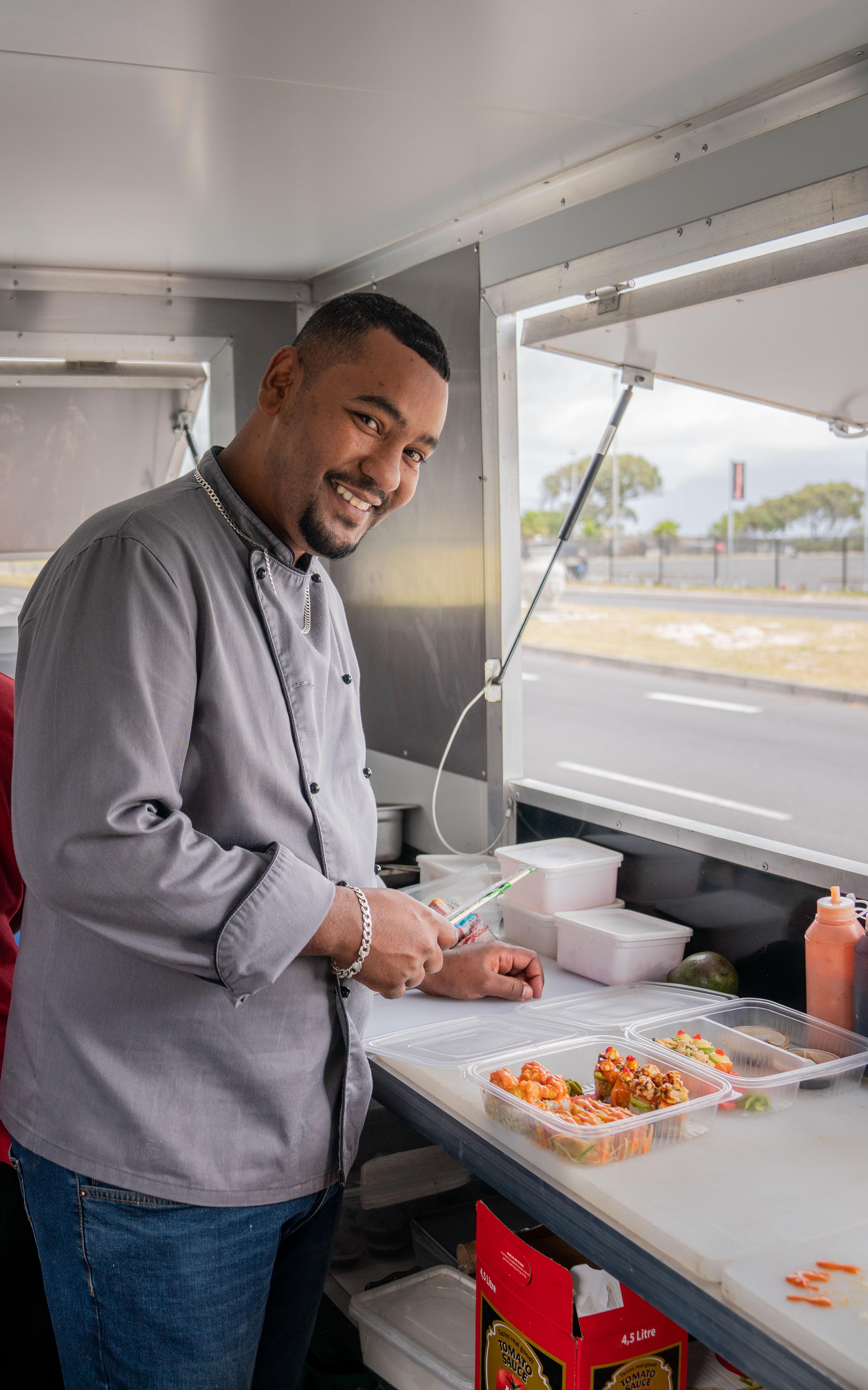 Beautiful News-Man preparing sushi in a food truck