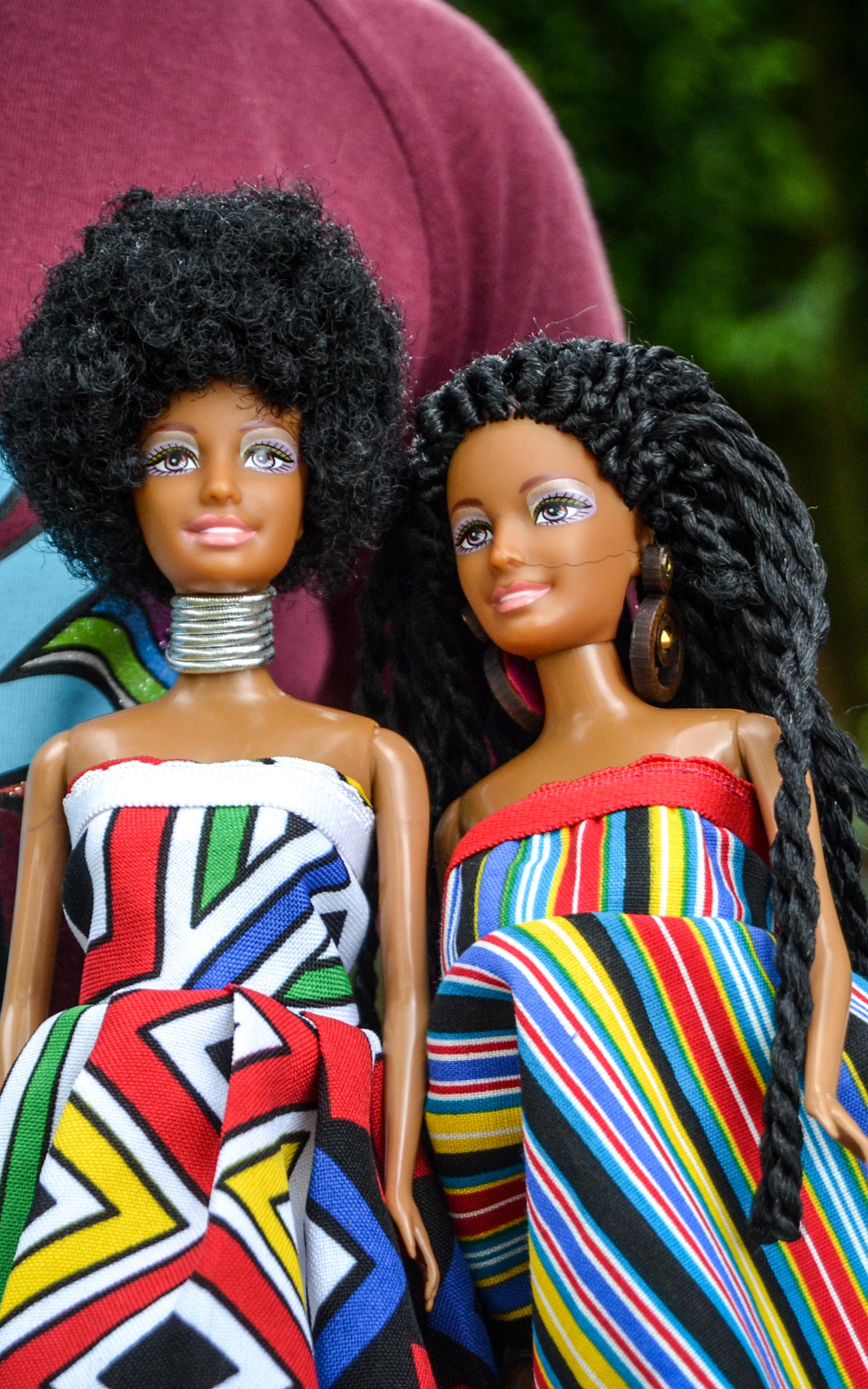Beautiful News-Child displaying two dolls