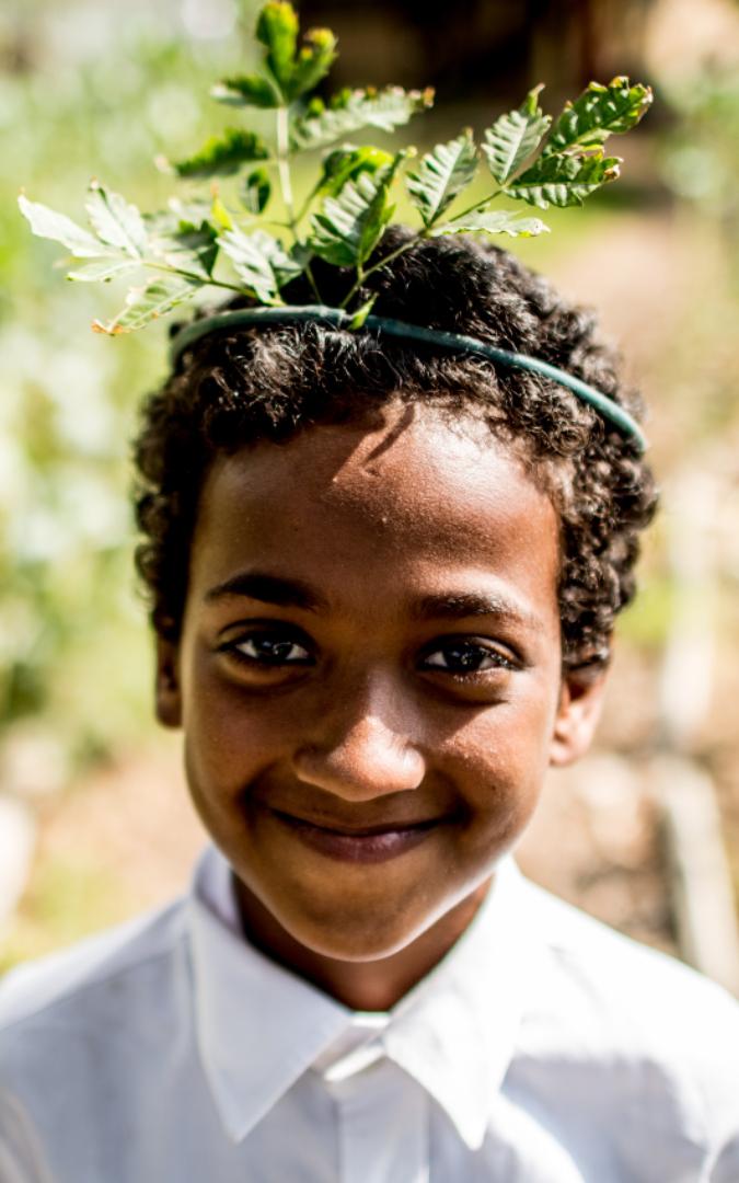 Young boy with grass crown.