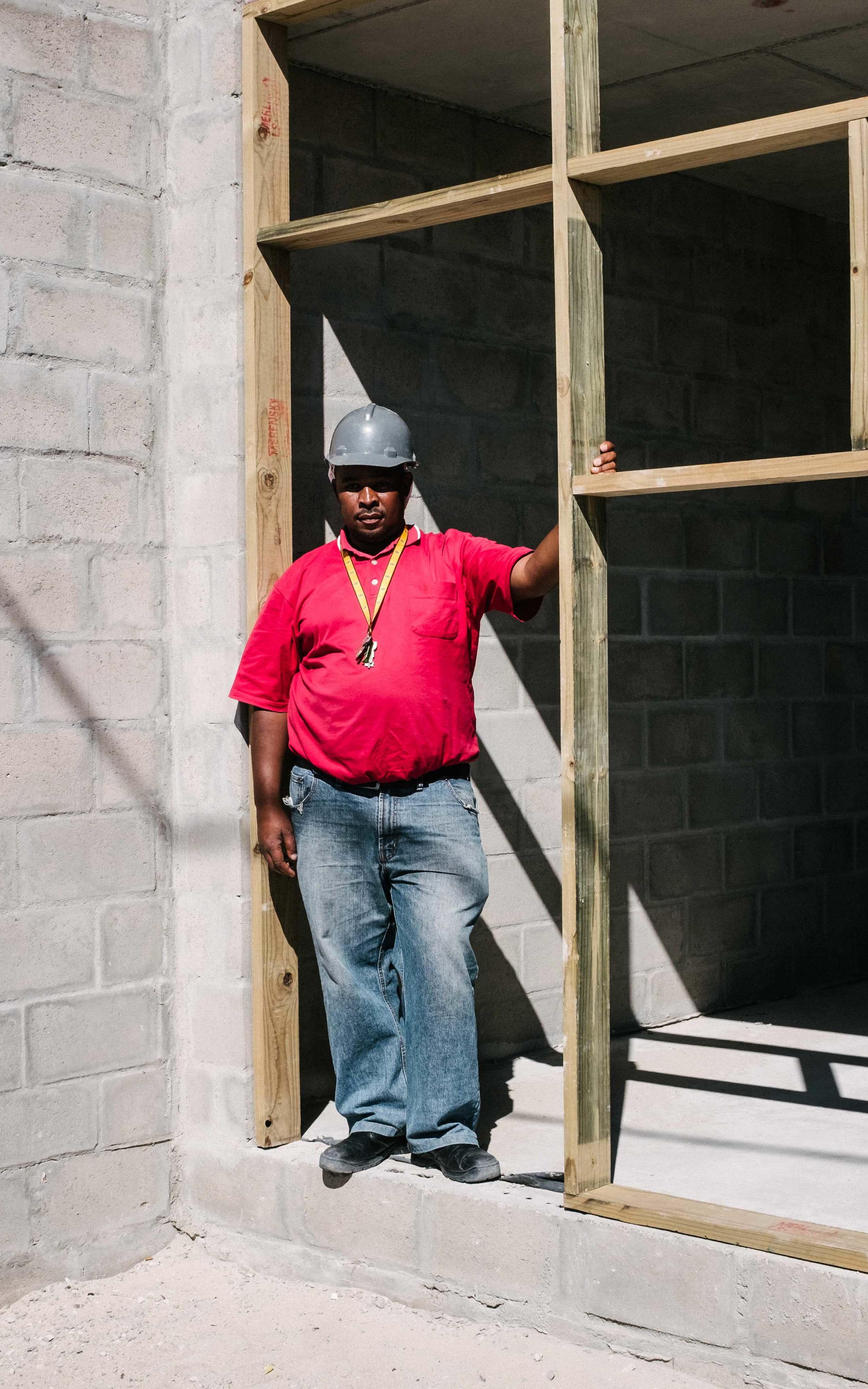 Builder standing at construction site