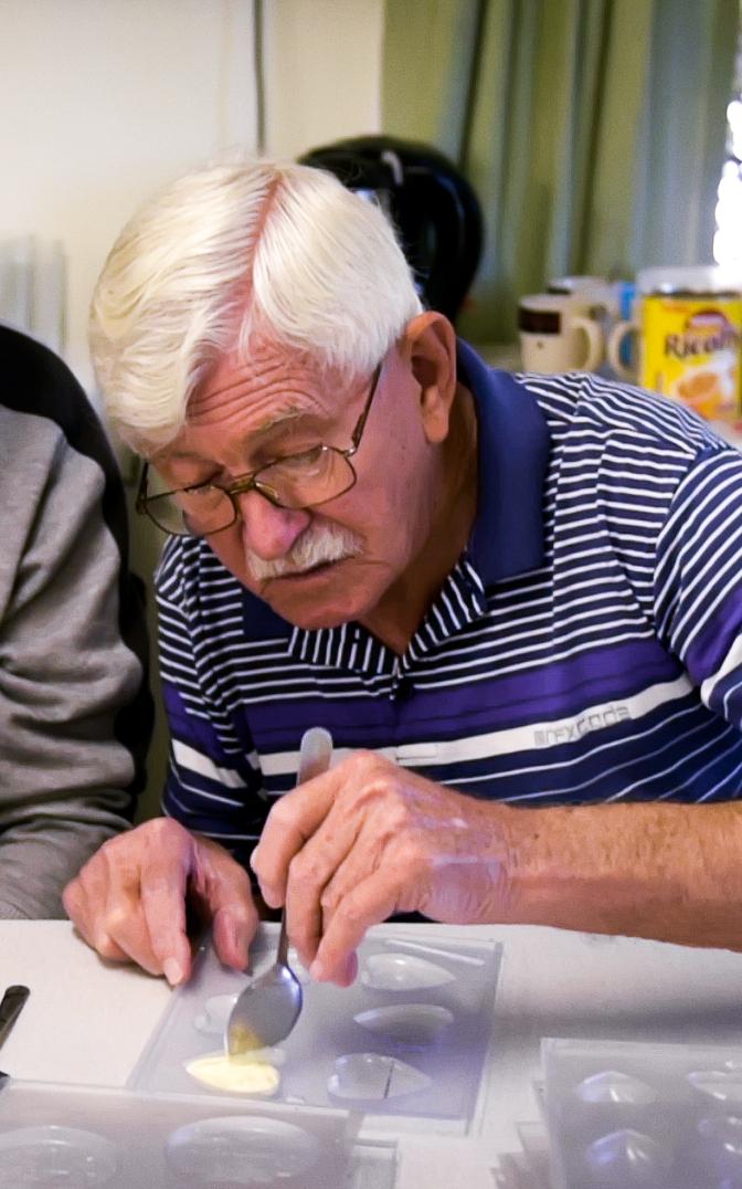 Two elderly men making chocolate